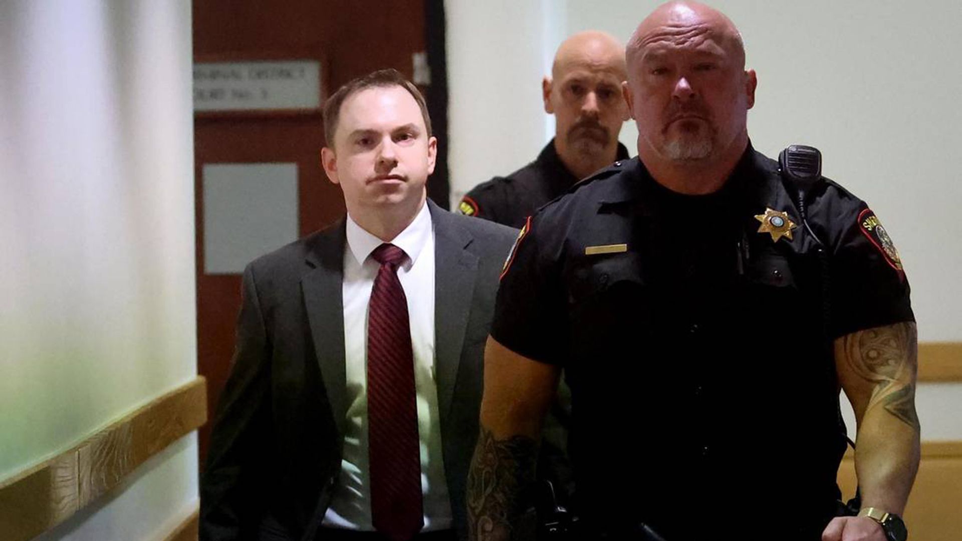 Aaron Dean is led by court bailiffs through the Tarrant County courthouse