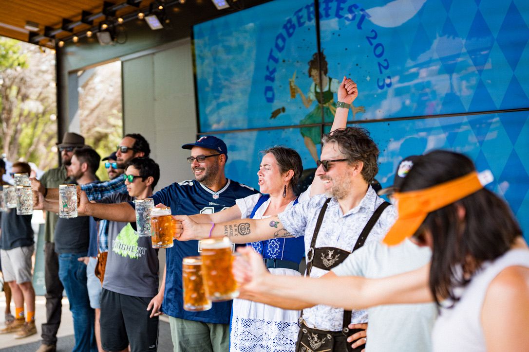 A photo of people holding beer up.