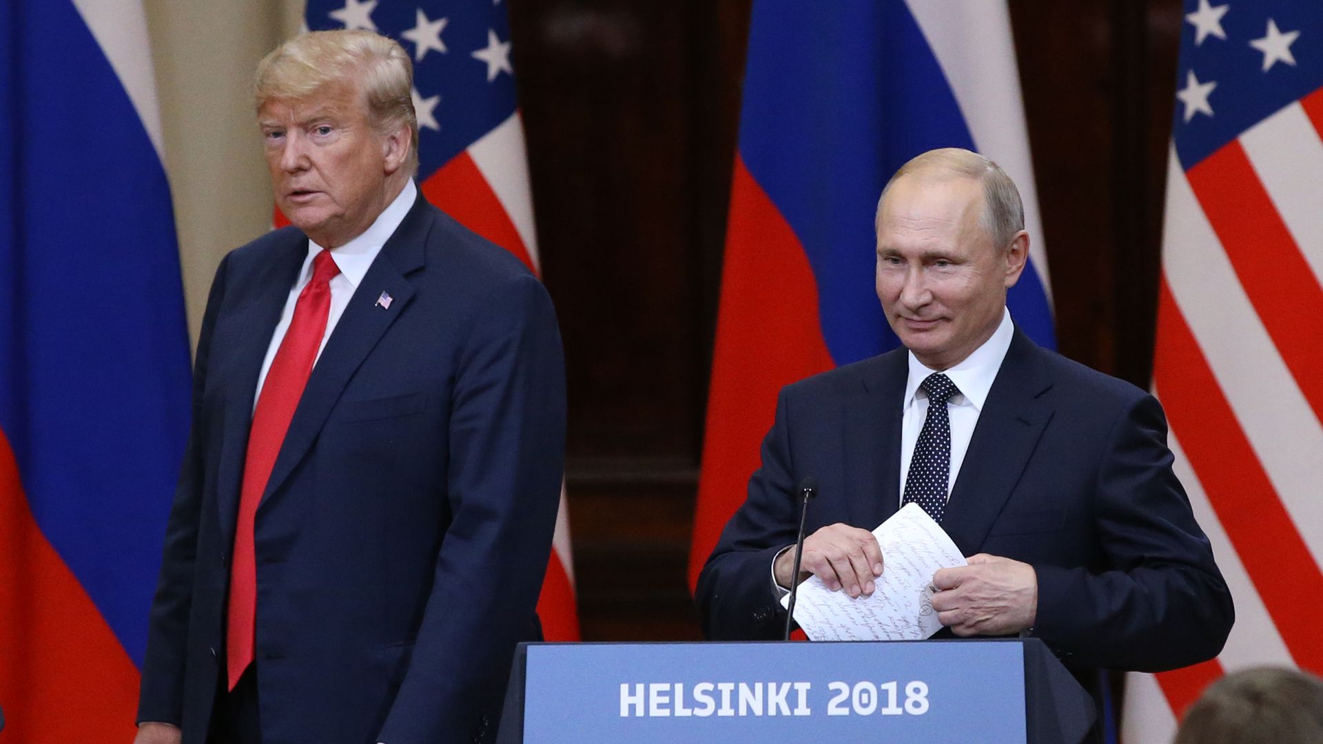 President Donald Trump and Russian President Vladimir Putin arrive for a joint press conference after their summit on July 16, 2018 in Helsinki, Finland. 