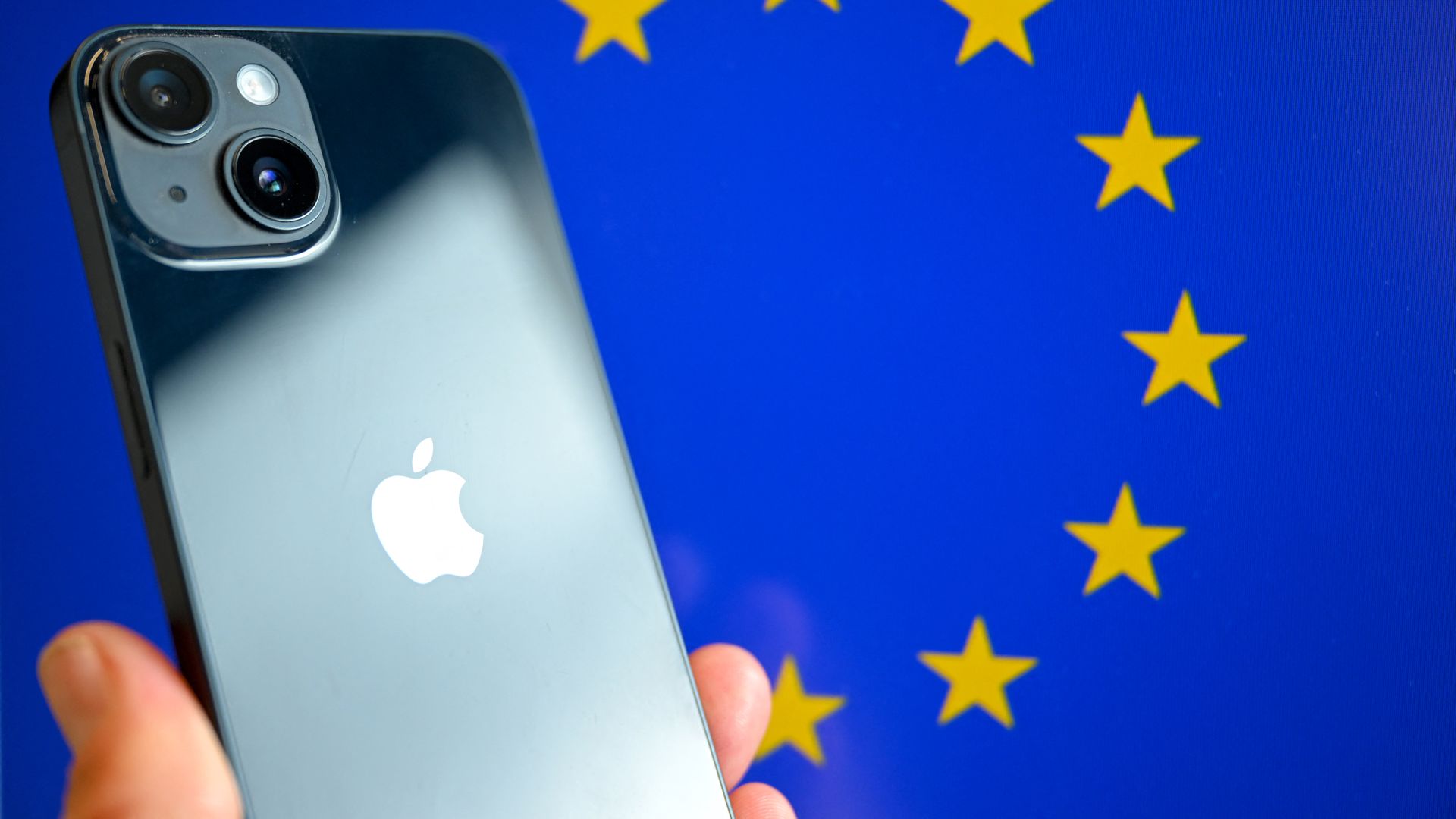 smartphone with the Apple company logo and the European Union logo in the background