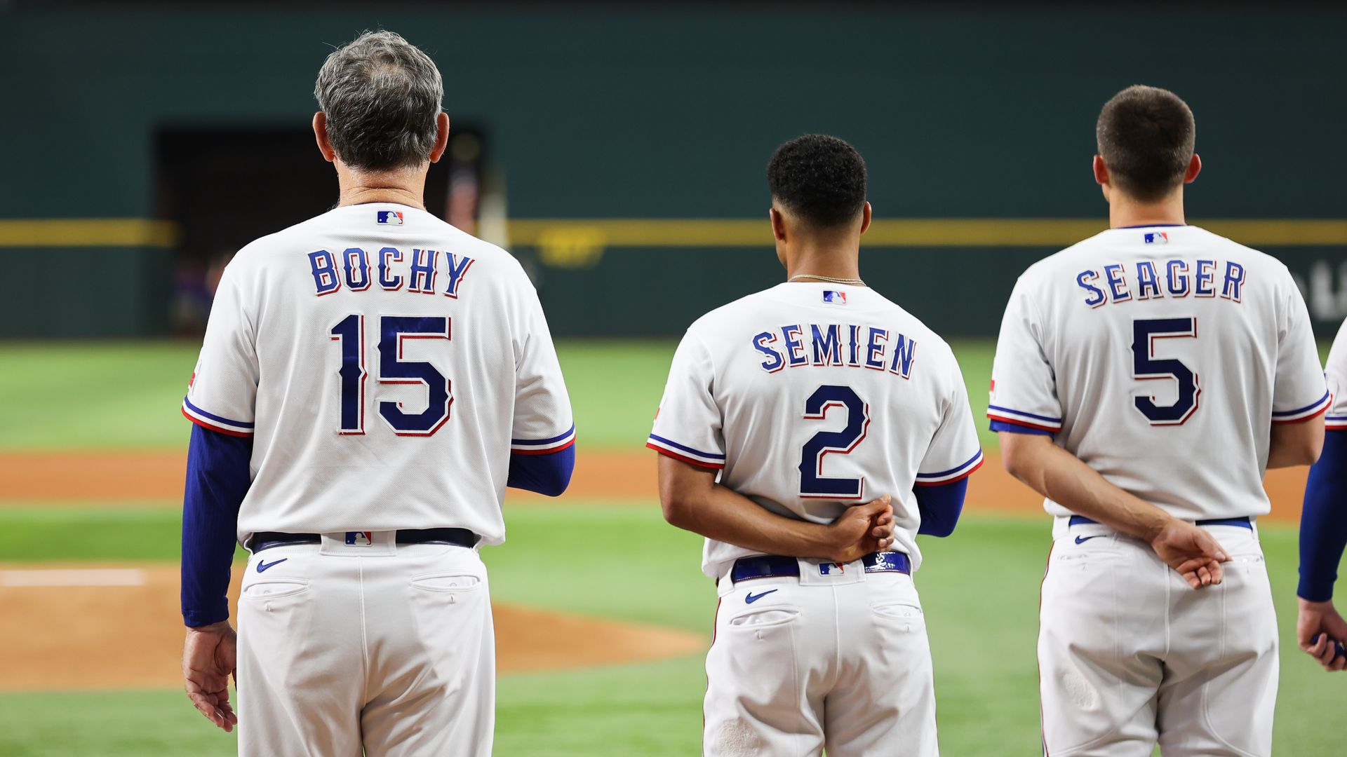 Texas Rangers manager Bruce Bochy, second baseman Marcus Semien and shortstop Corey Seager stand together for the national anthem.