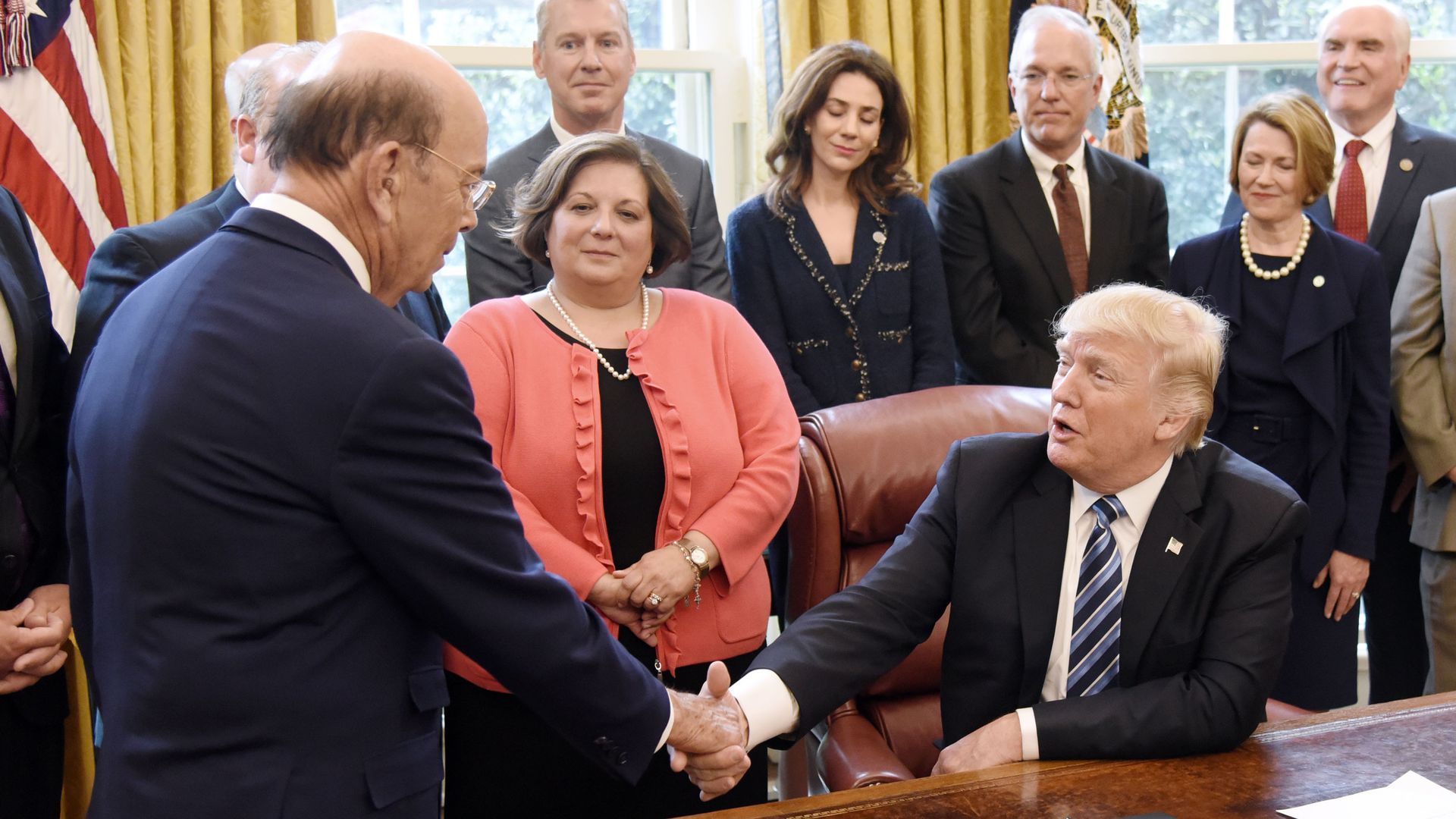 Trump shaking hands over tariff annoucement
