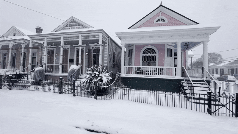 A camera view as it pans past three shotgun houses.