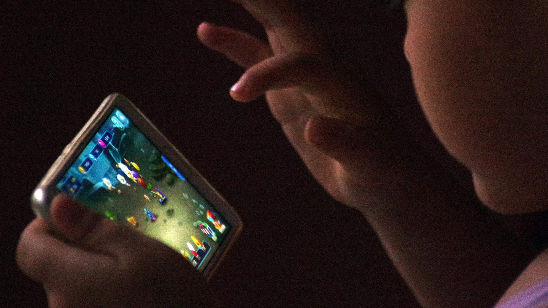 A child plays online mobile game. 