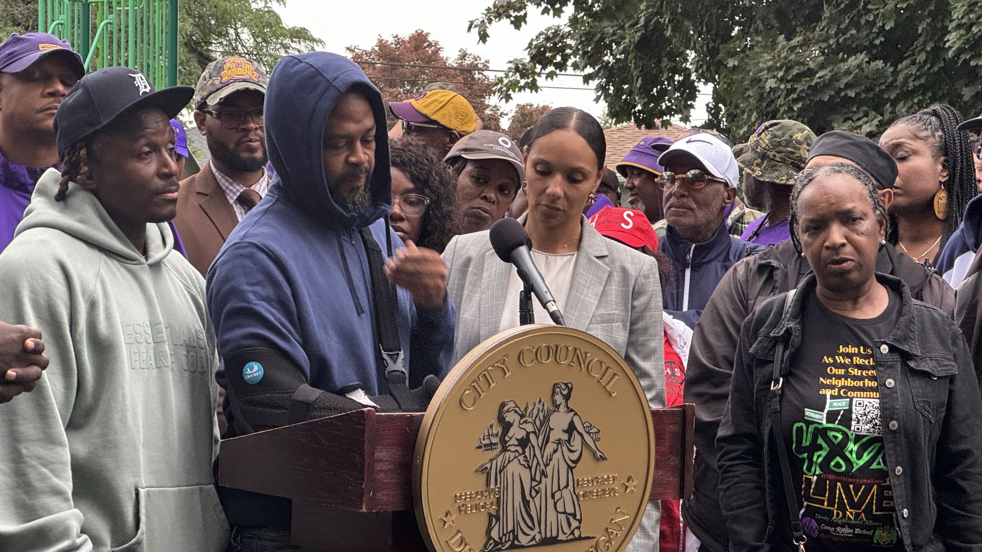 Quincy Graham stands beside City Council President Mary Sheffield to reflect on losing his niece, Shanae Fletcher, 20, who was killed in the mass shooting last weekend. 