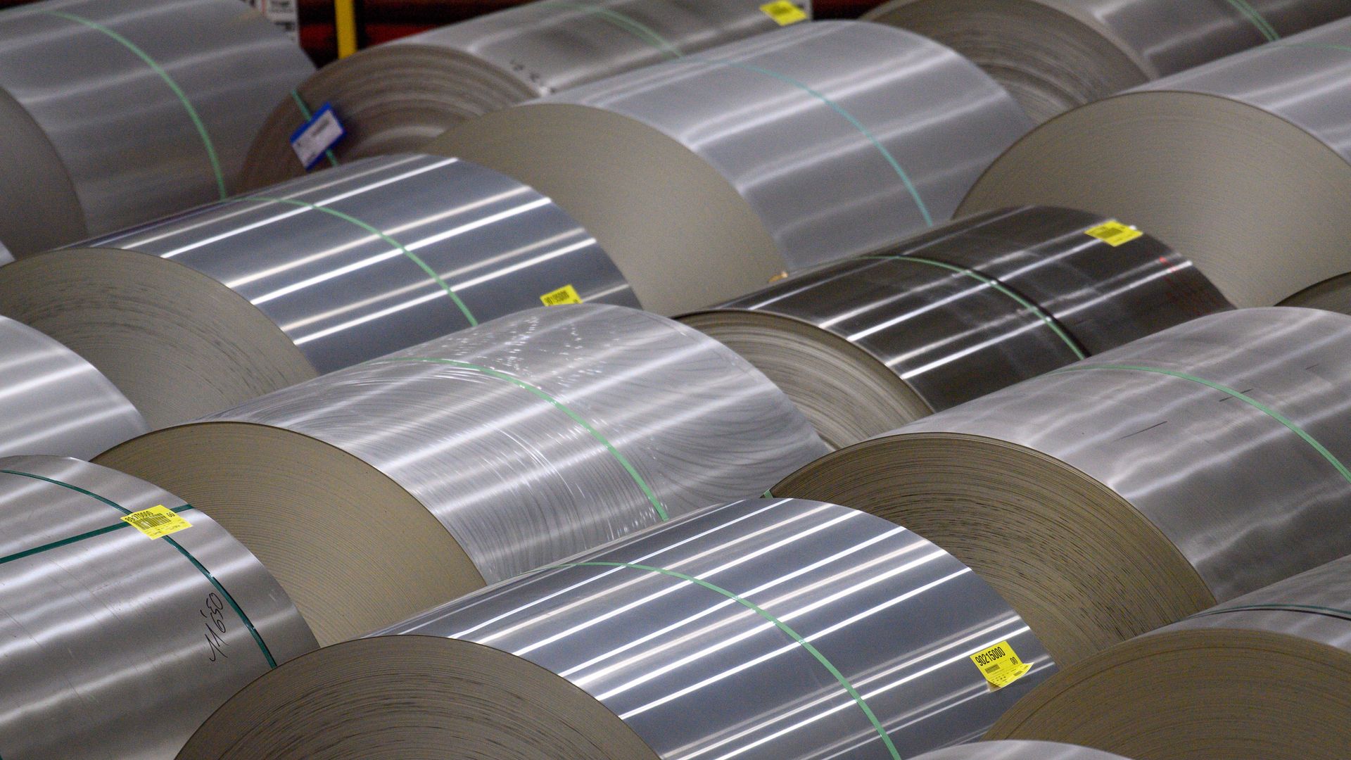 Rolls of aluminum laying on their sides. 