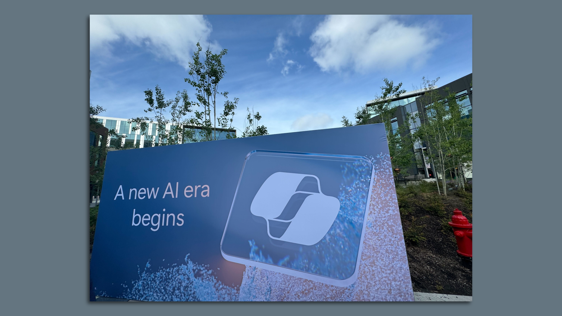A sign that says "A new AI era begins" with the Microsoft Copilot logo