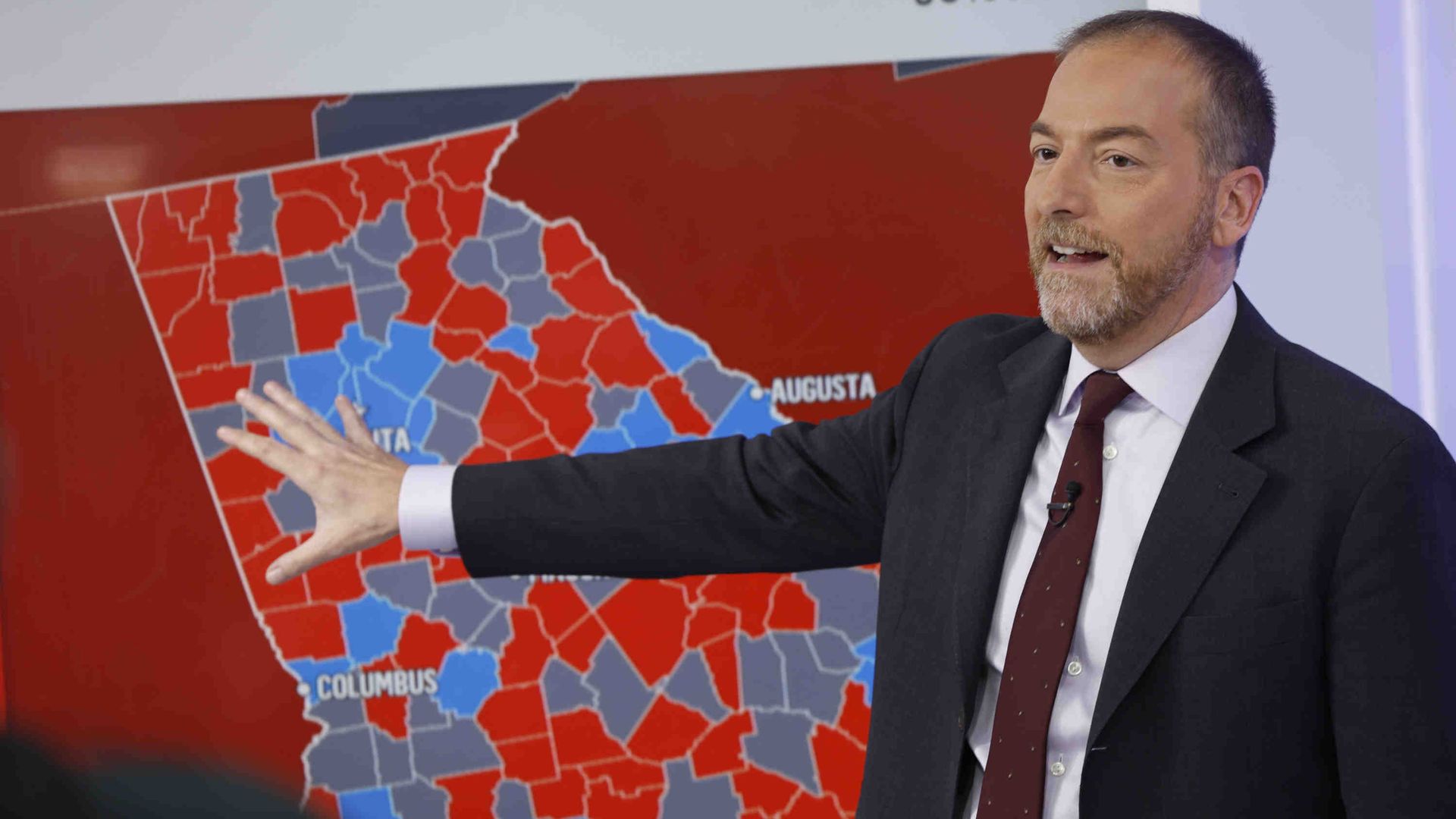 Chuck Todd stands in front of a map of Georgia that displays individual voting results for state counties.