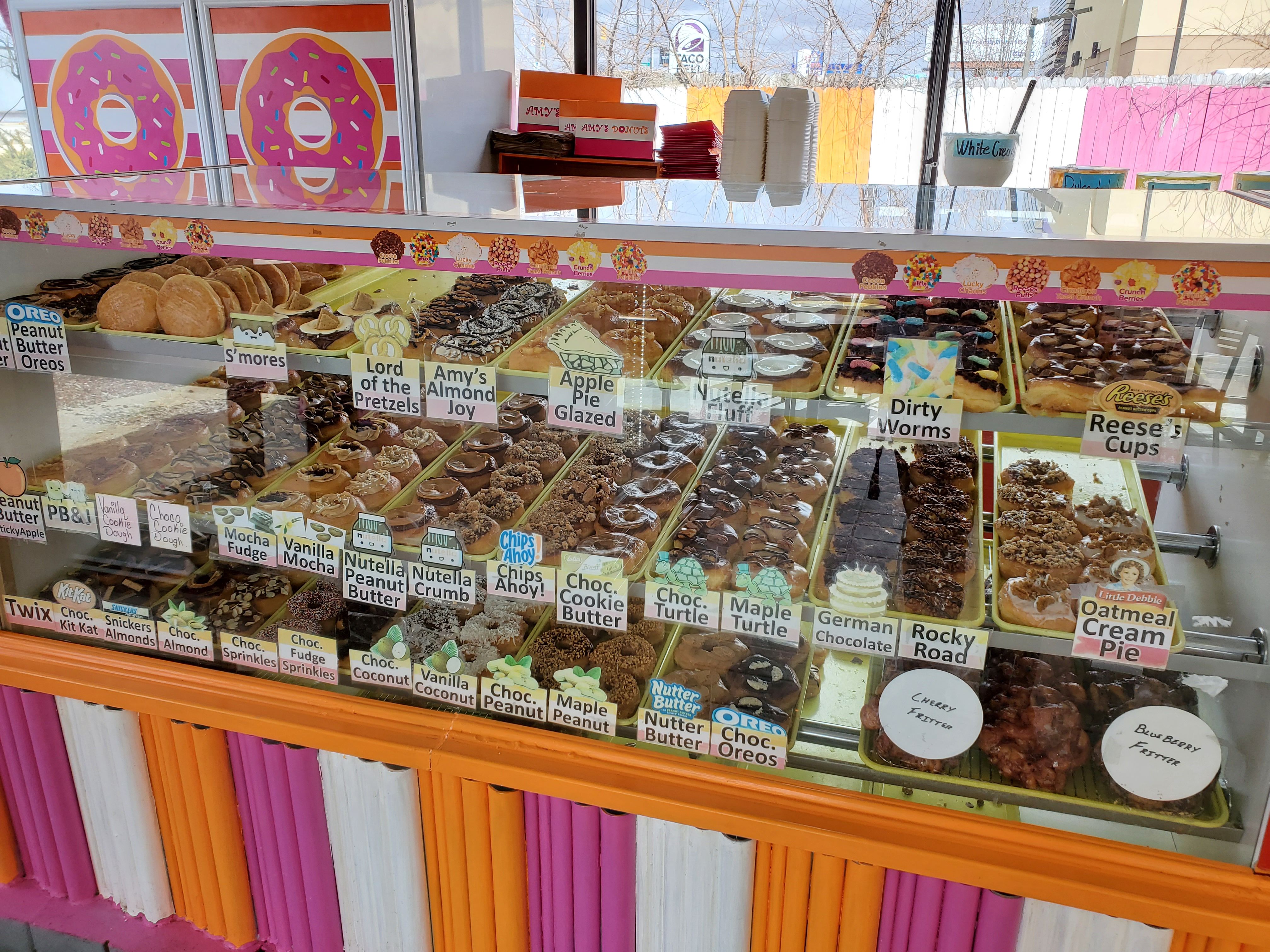 A counter with rows of donuts