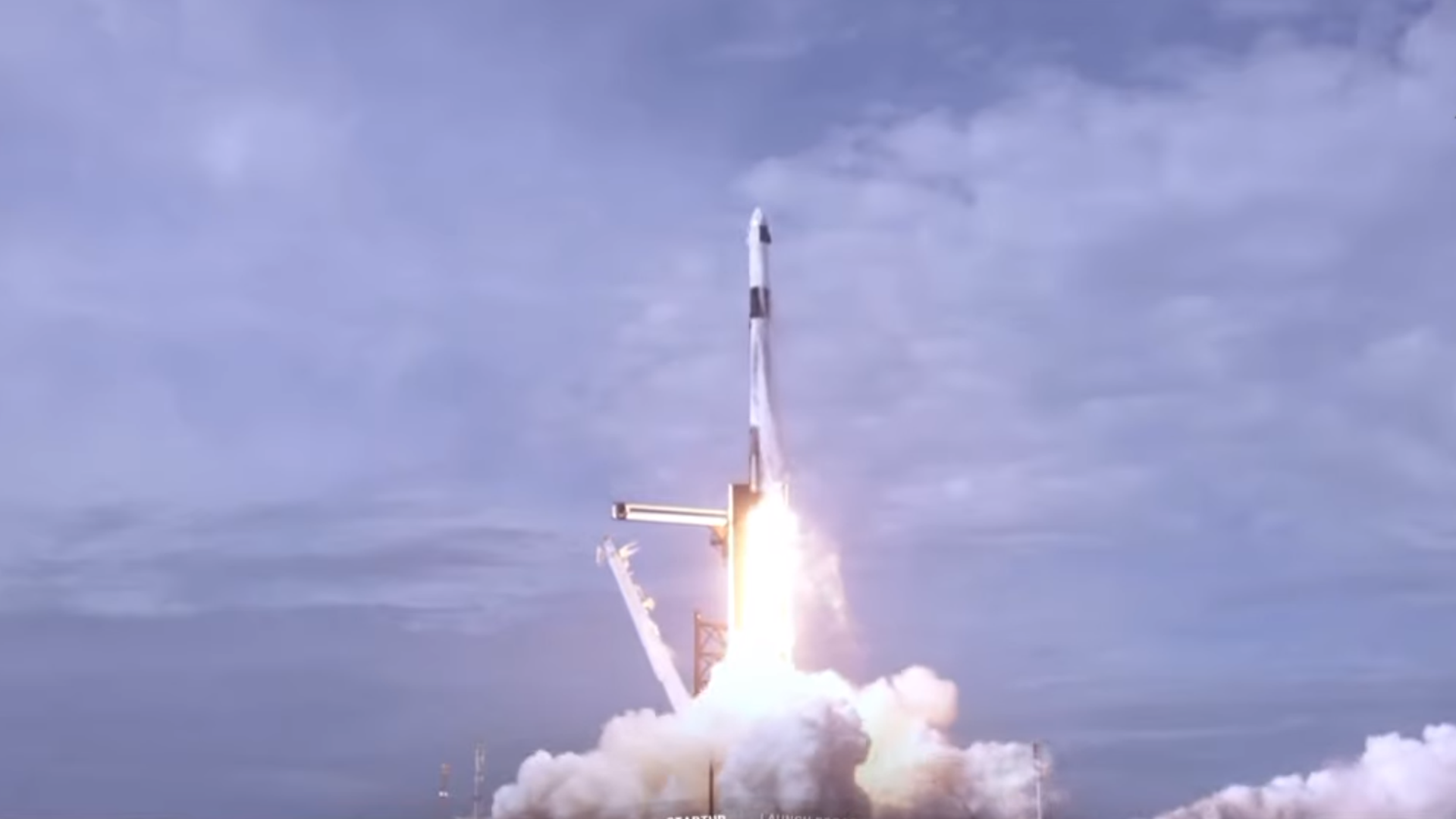 A SpaceX Falcon 9 rocket launching with a Crew Dragon atop