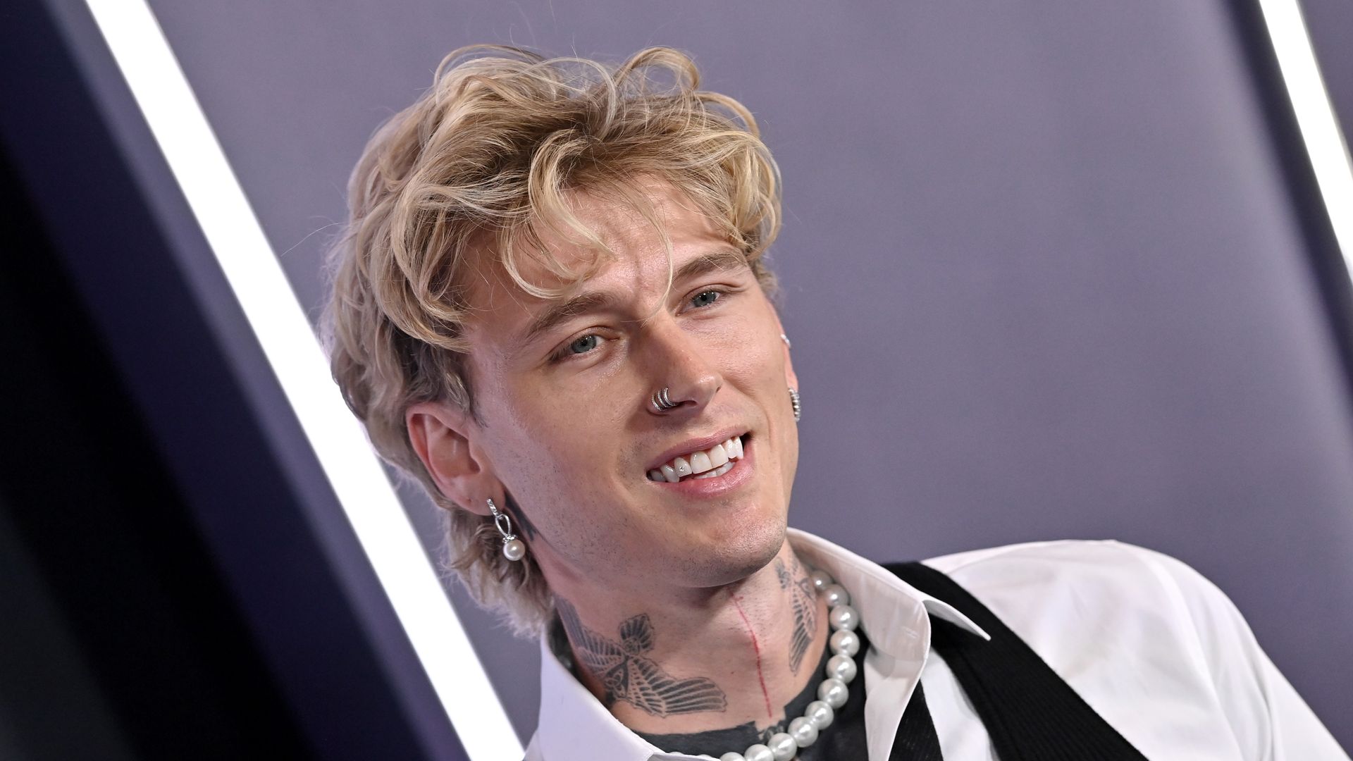Machine Gun Kelly poses for ap hoto on the red carpet. 