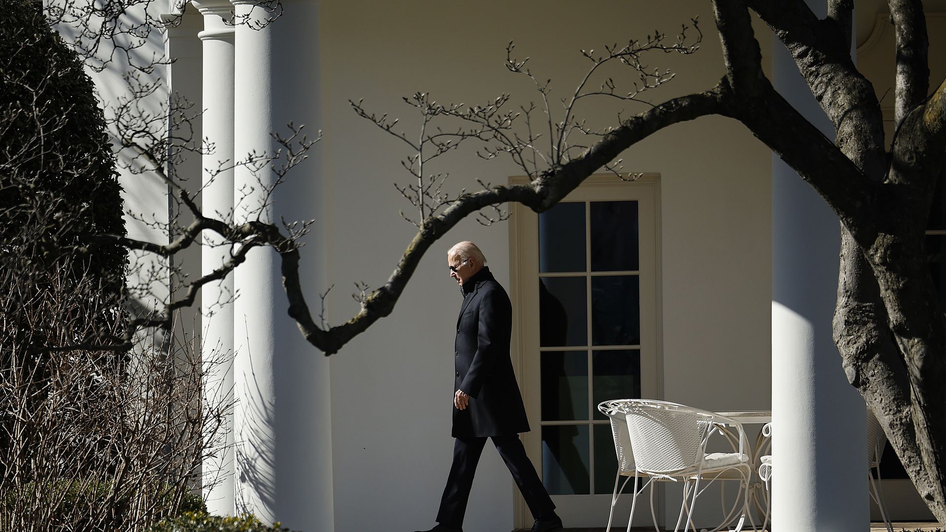 Joe Biden, mid-stride outside the Oval Office, on a bright winter's day