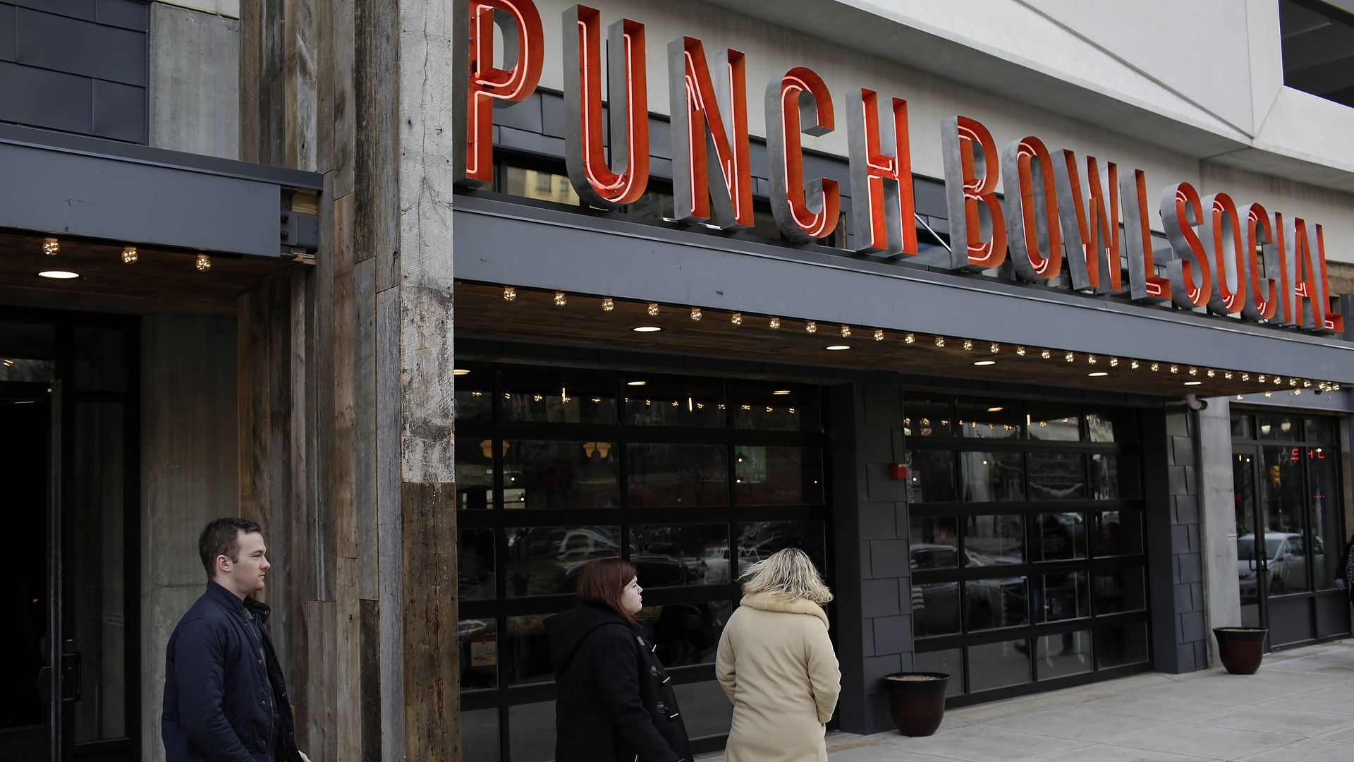 TO GO WITH AFP STORY by Joe Szczesny, US-city-Detroit-auto-debt Patrons exit the new Punch Bowl Social restaurant January 1, 2015 in Detroit, Michigan. After the largest municipal bankruptcy in US history, Detroit hopes outsiders will see the city's potential not the history of racial conflict, fina