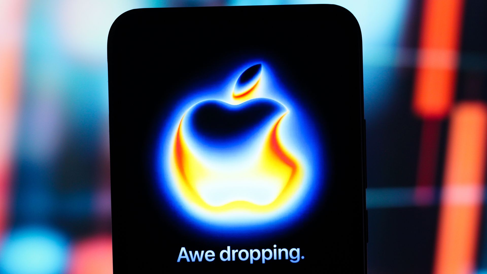 A smartphone displays the Apple "Awe Dropping" logo for the iPhone 17 launch.
