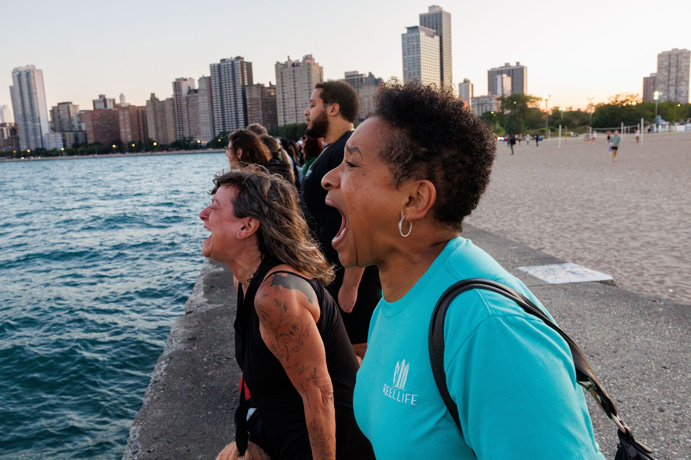 A group of people scream overlooking Lake Michigan