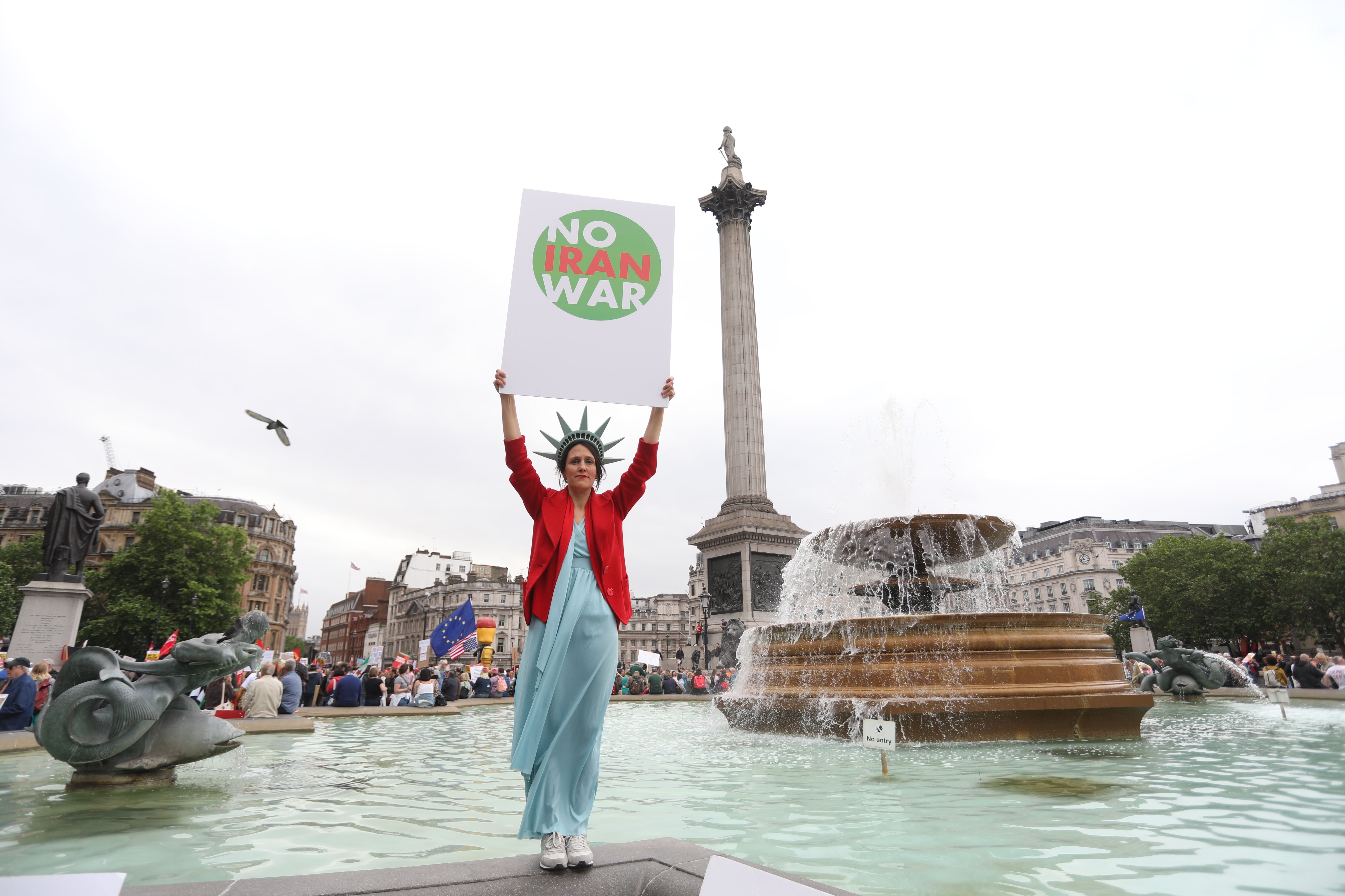 A demonstrator holds up a placard as protesters against the US president's State Visit gather in Trafalgar Square in central London on June 4, 2019.