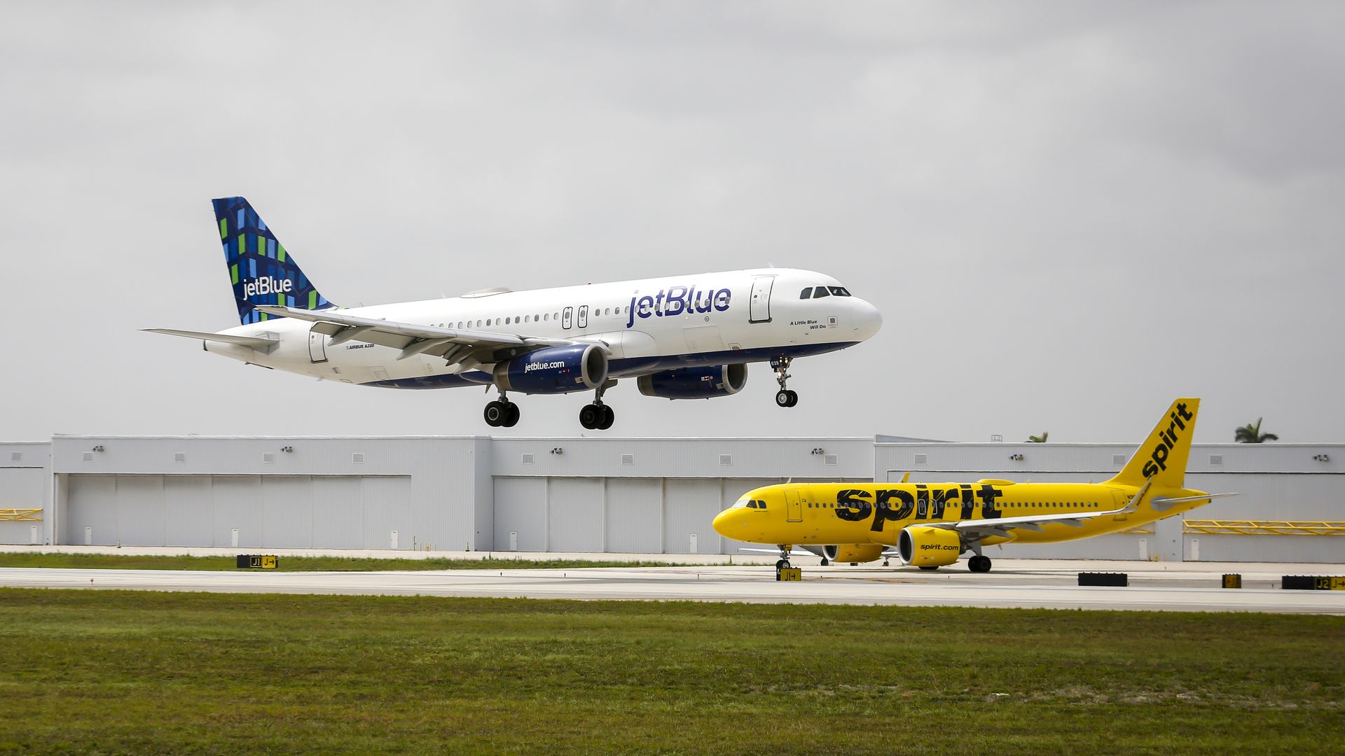 JetBlue and Spirit airplanes at Fort Lauderdale-Hollywood International Airport (FLL) in Fort Lauderdale, Florida, US, on Saturday, May 21, 2022. 