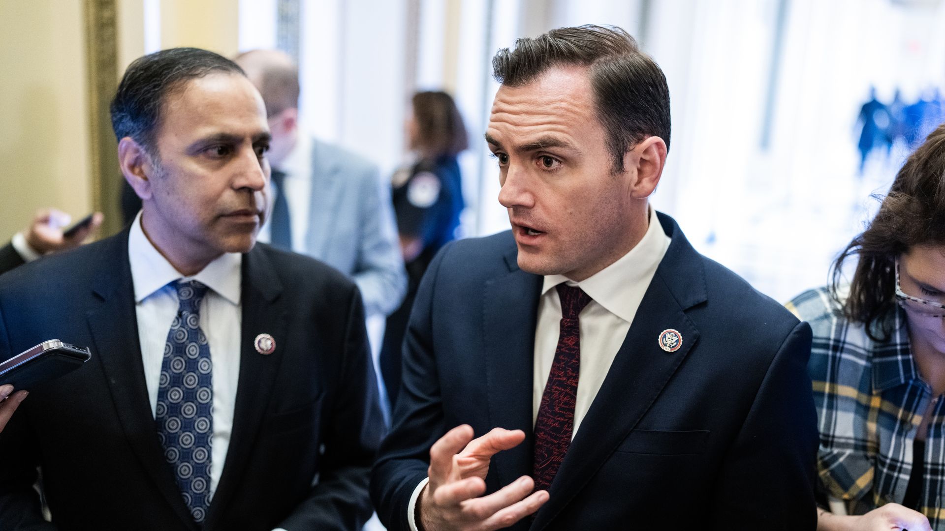 Reps. Mike Gallagher, R-Wis., right, and Raja Krishnamoorthi, D-Ill., talk with reporters 