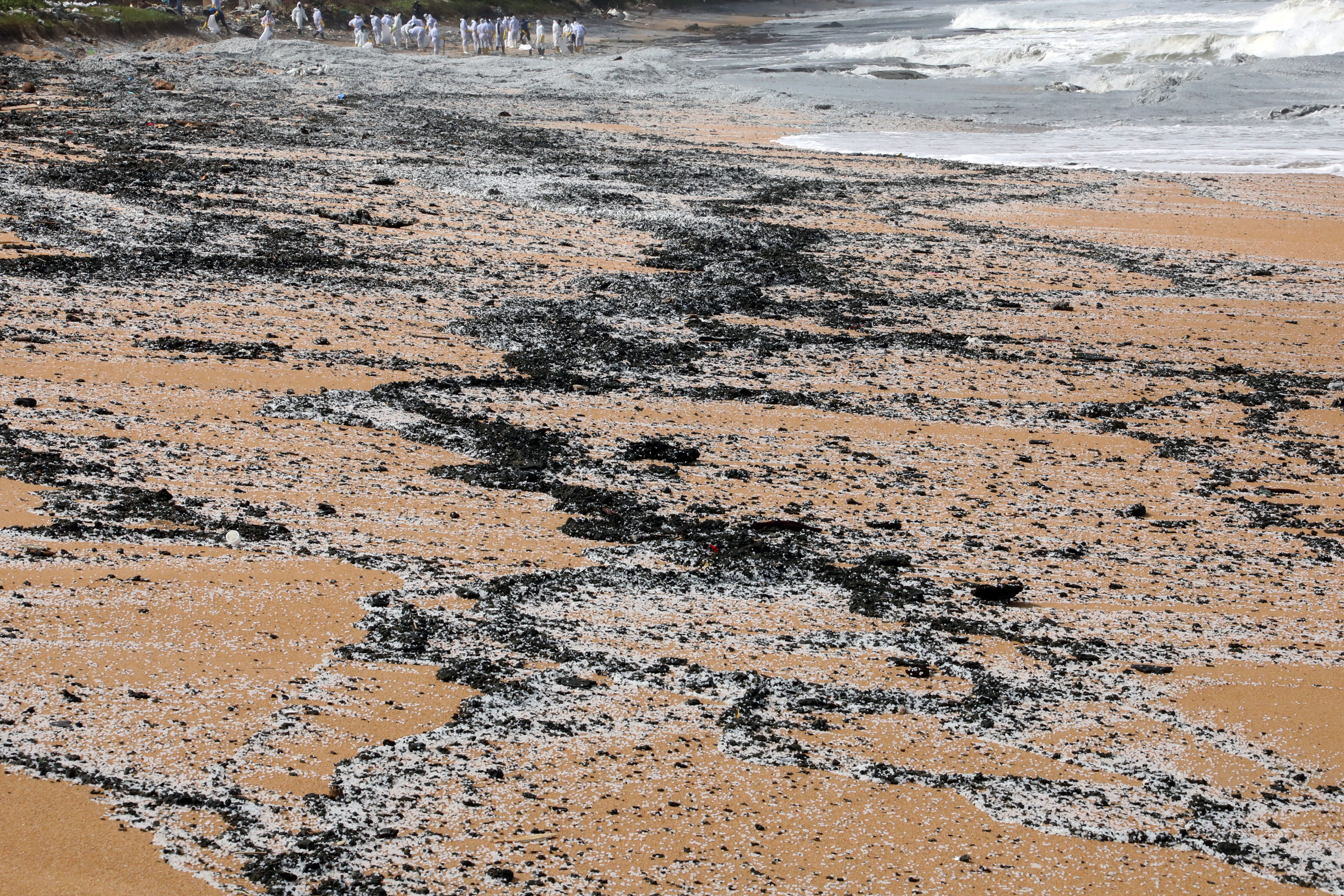 Debris and chemical granules used to manufacture plastic washed ashore in Sri Lanka