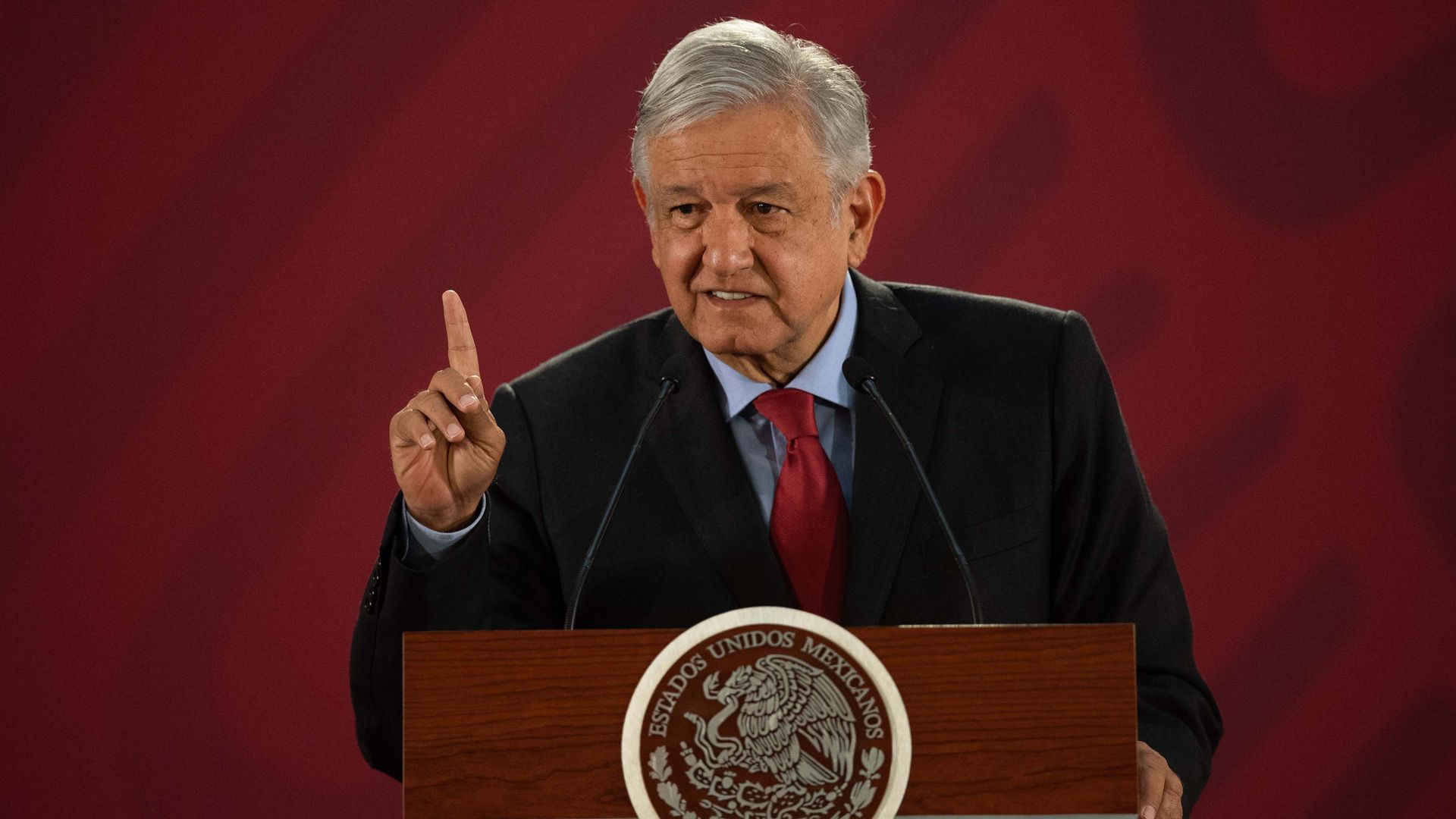In this image, the Mexican president stands and speaks behind a podium.