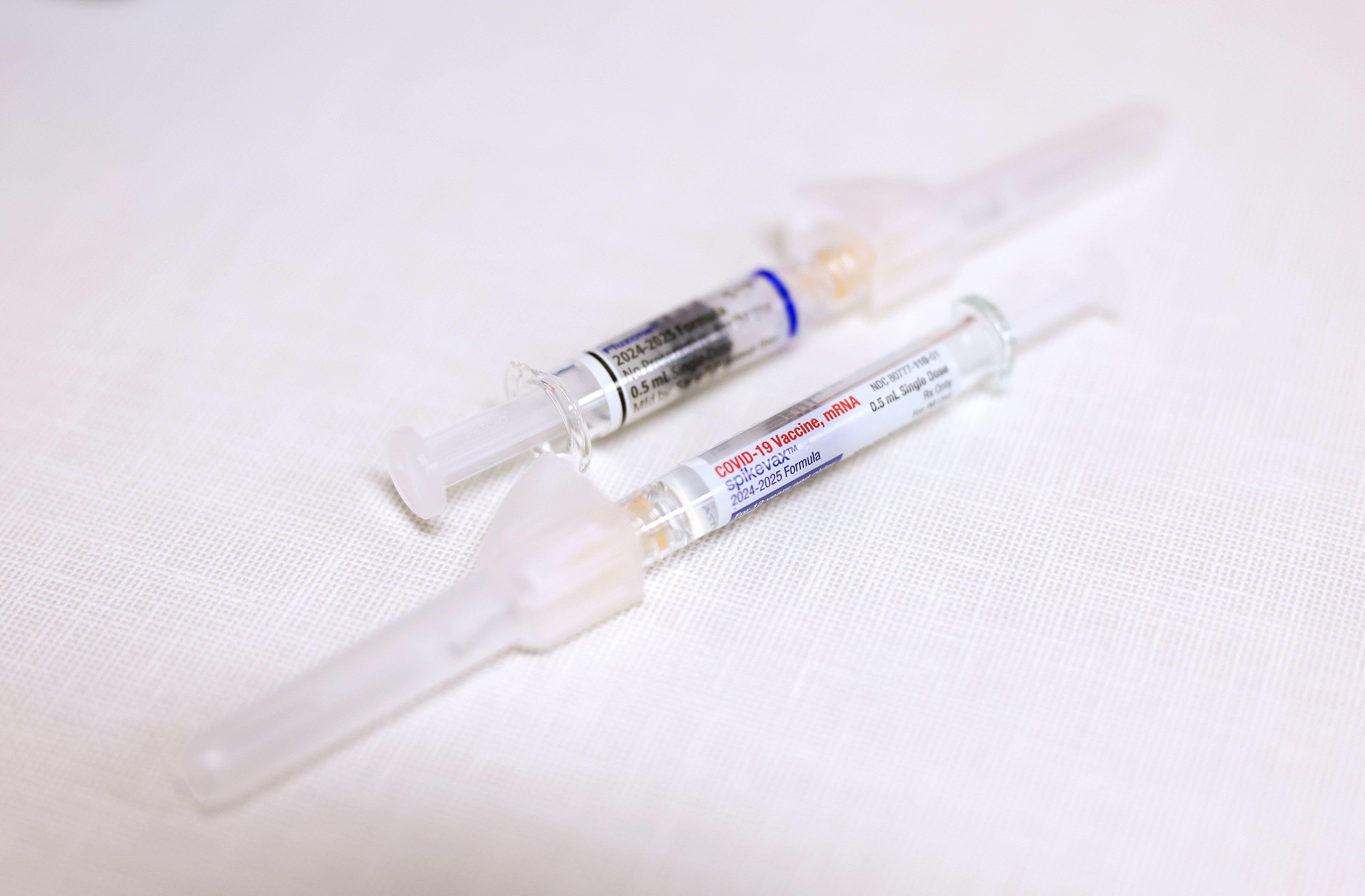 The flu and Covid-19 vaccines sit on a table