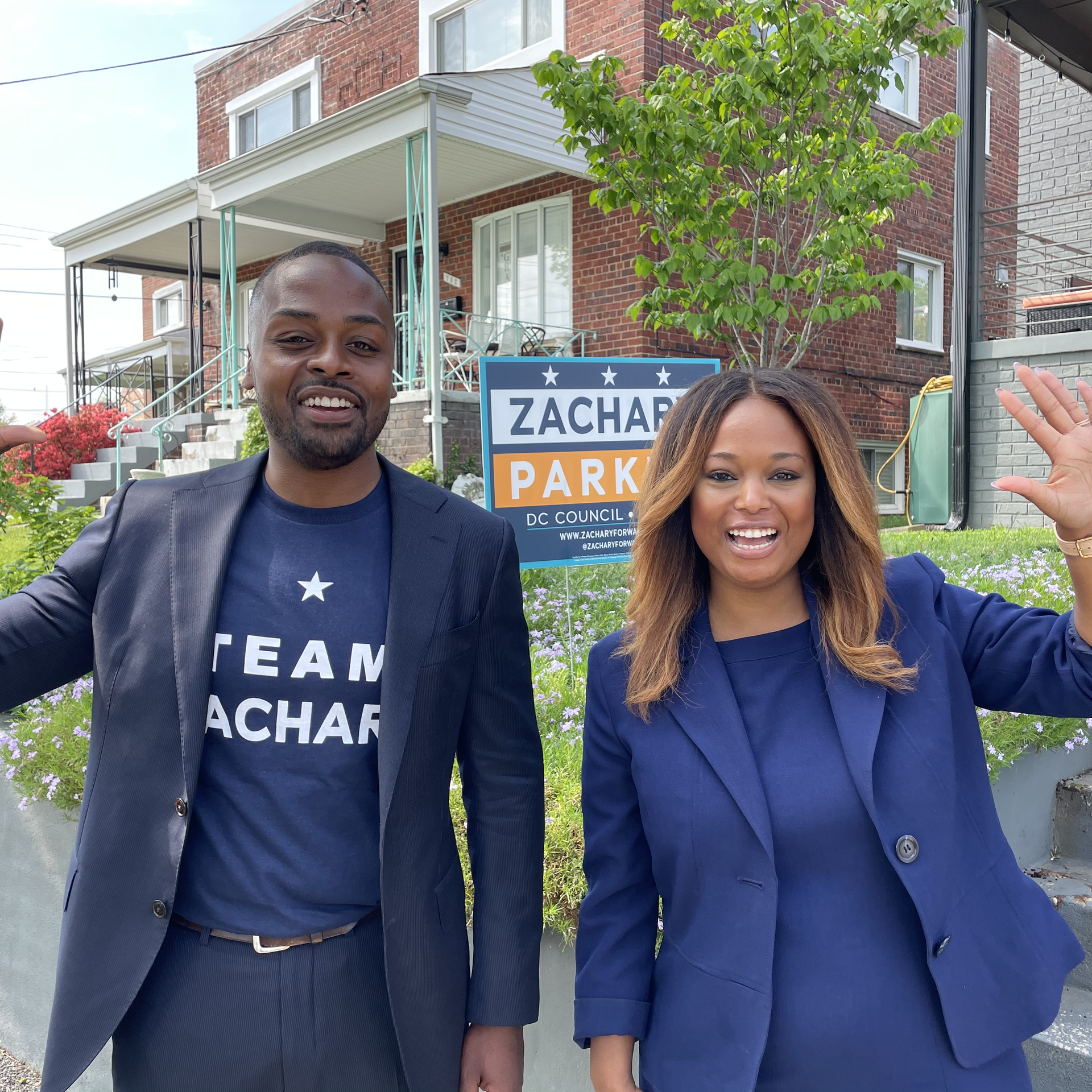 Zachary Parker (left) and Ward 4 Council member Janeese Lewis George stand side by side on a street of rowhouses
