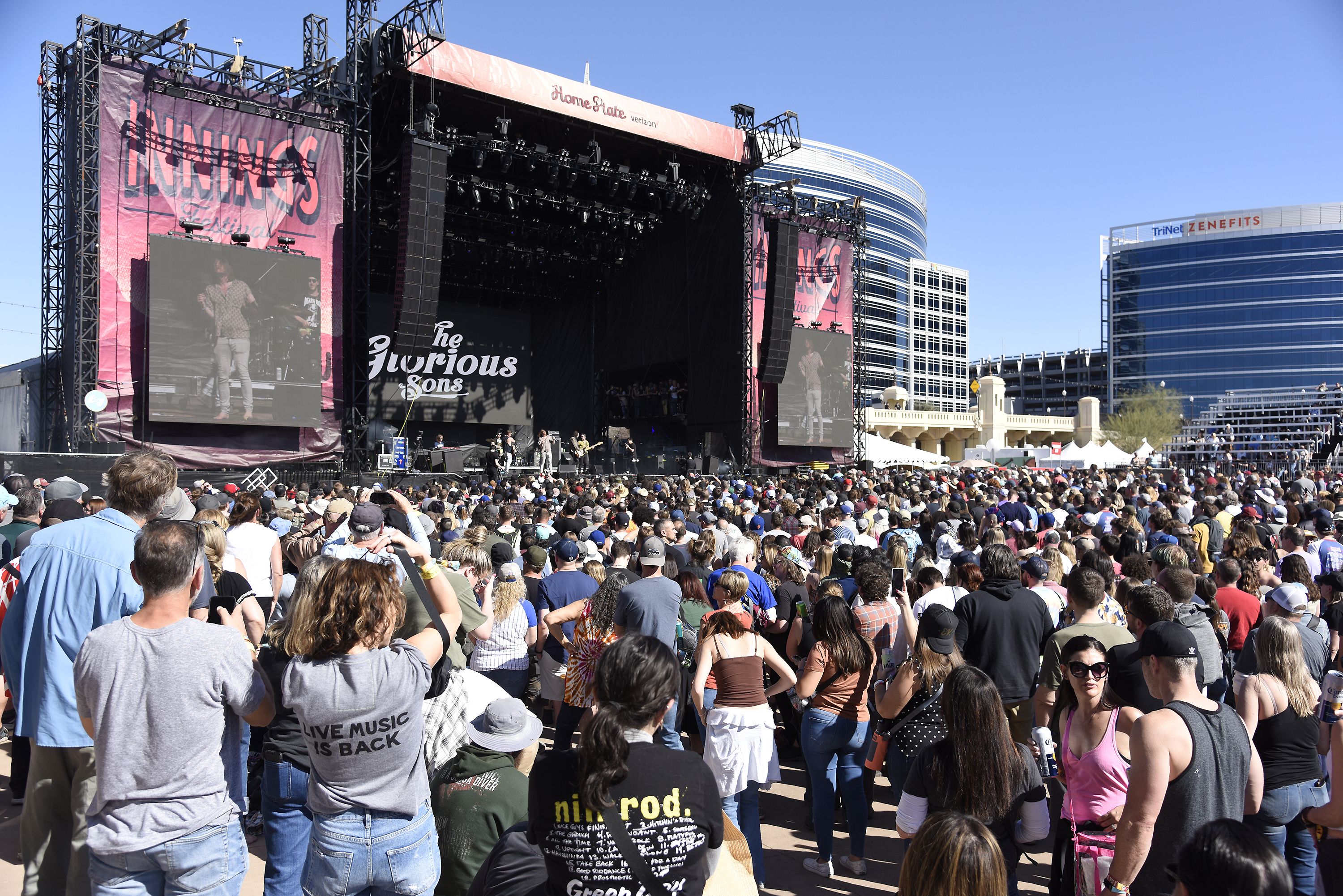 Photo of people standing at a concert 