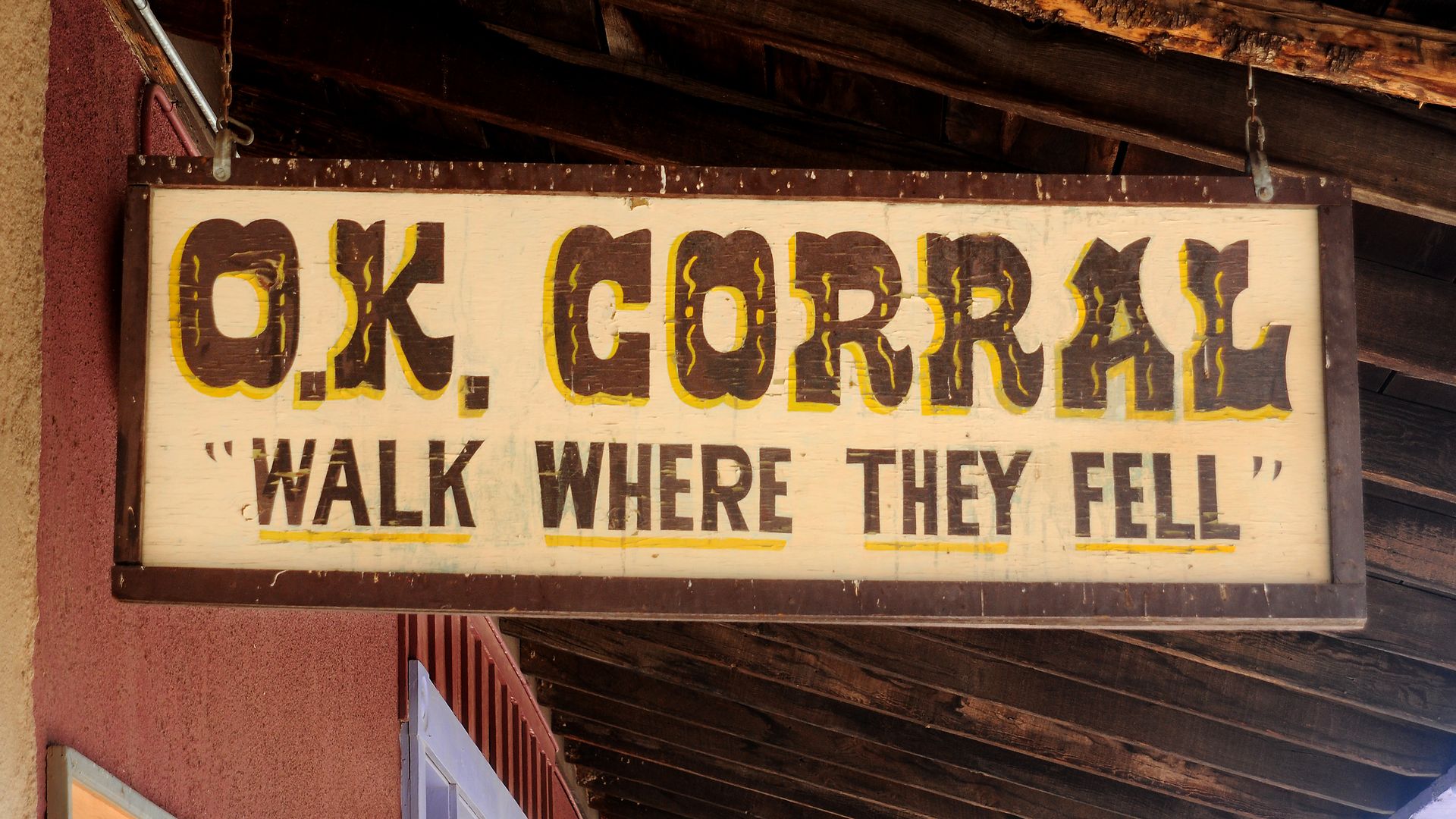 A sign that says, "O.K. Corral Walk Where They Fell."
