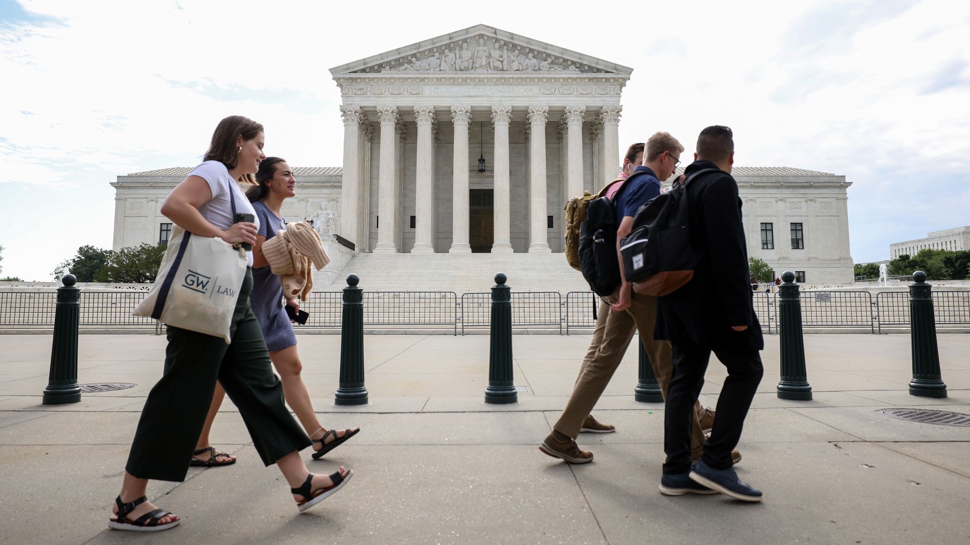 People walking outside of the Supreme Court in Washington, D.C., on June 10.