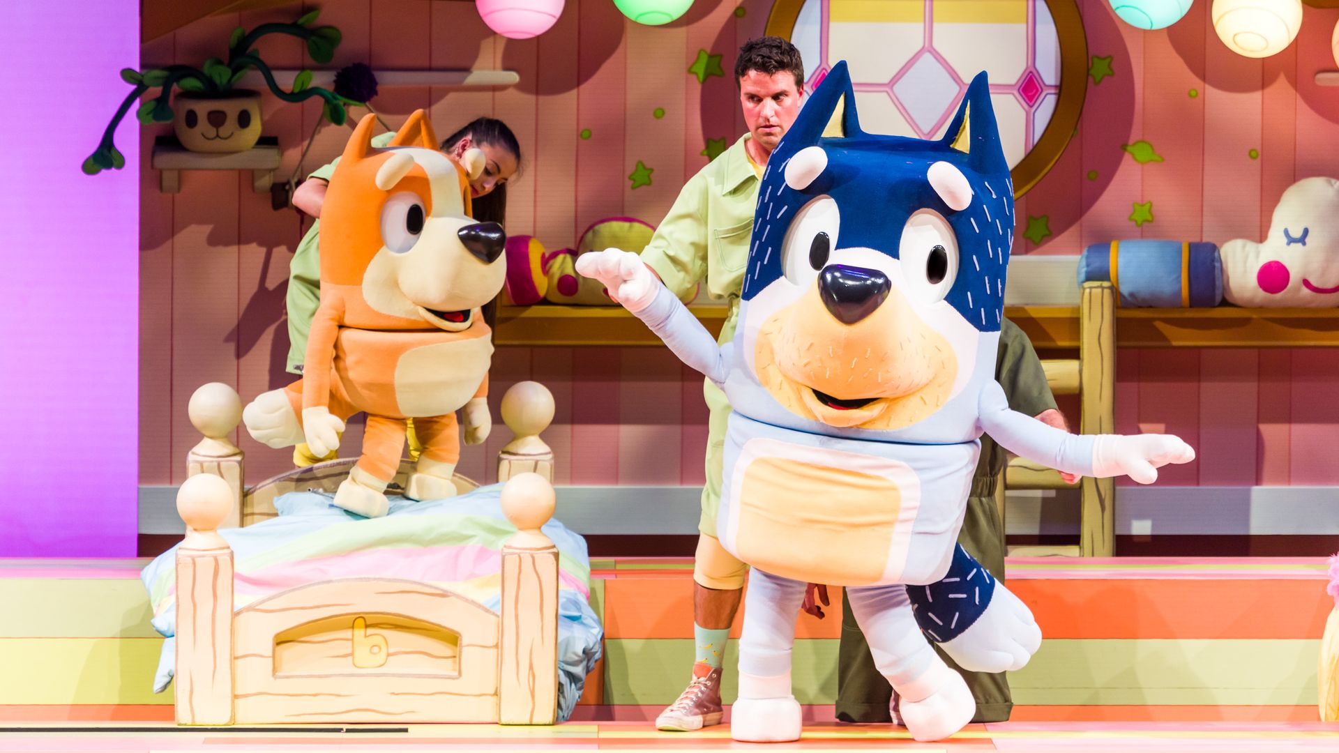 Photo of two mascot actors on stage in a kid's play