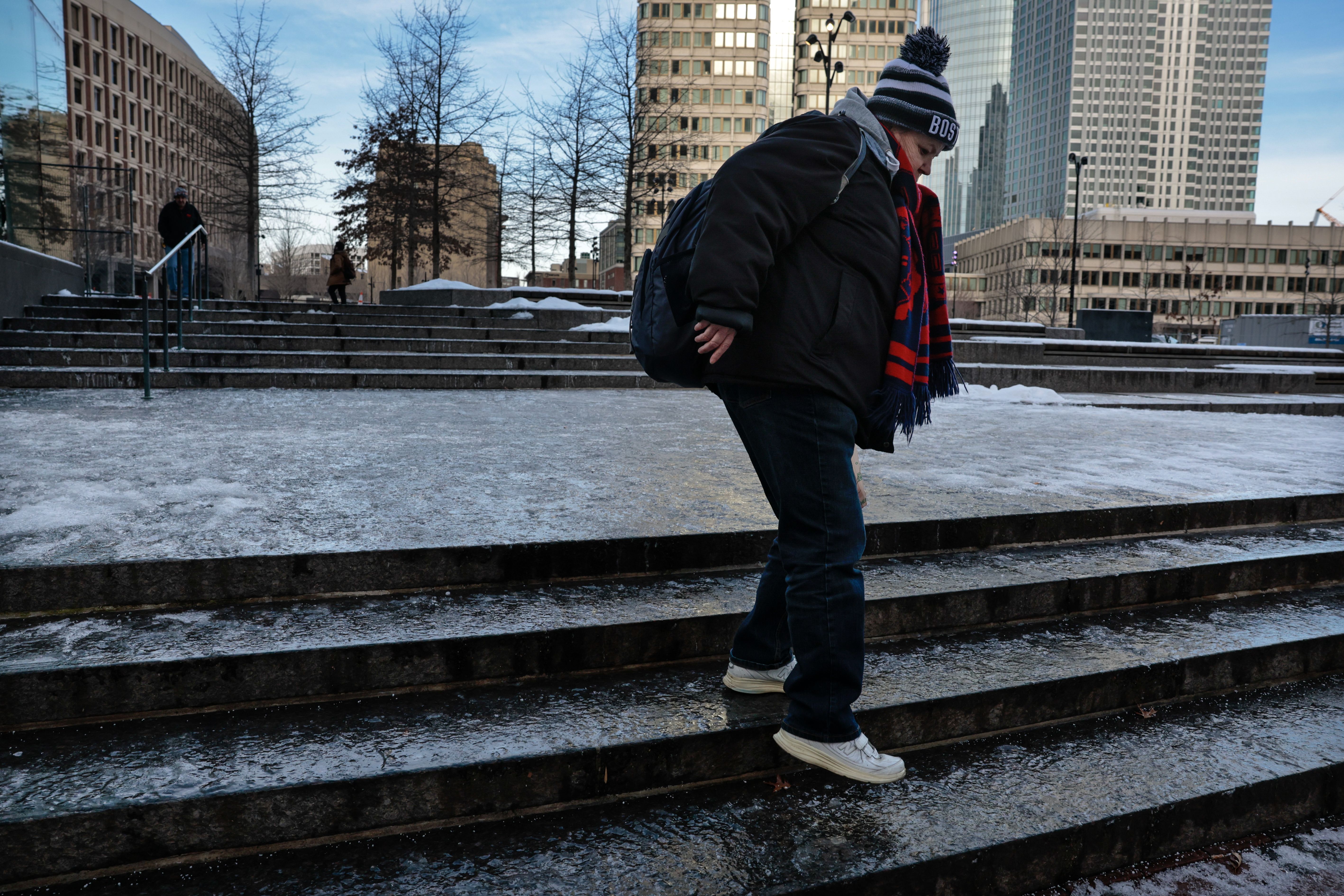 A person stepping down icy steps in Boston on Feb. 13.