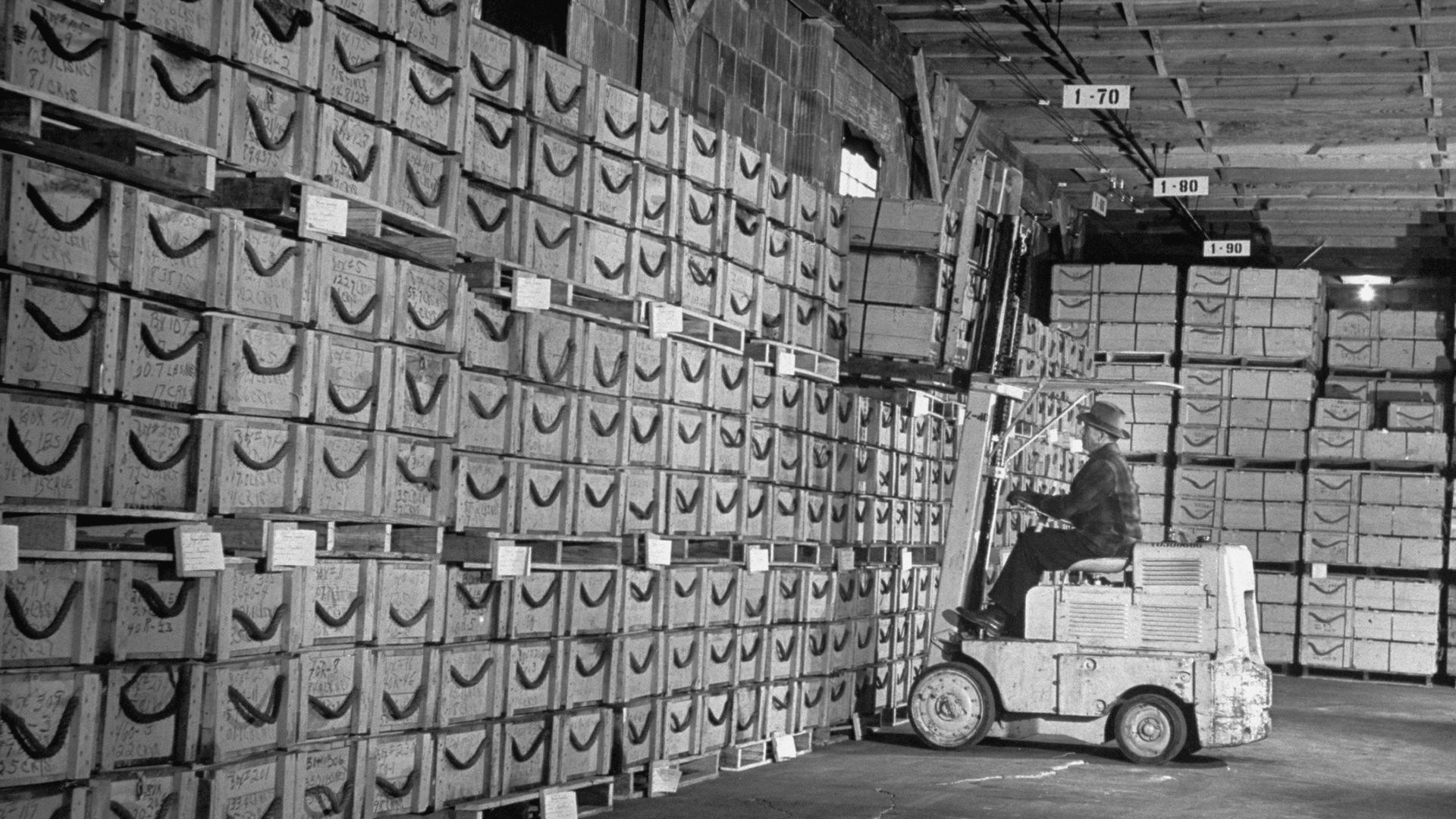A forklift operator lifts crates full of quartz crystals in this photo from 1948.