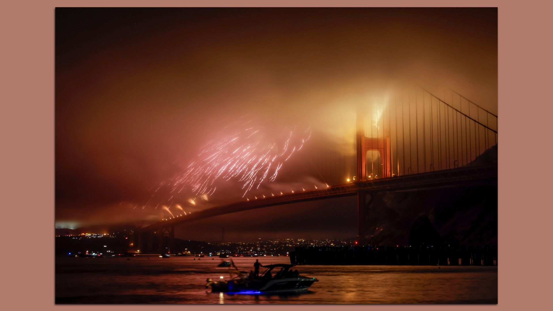 Image of fog engulfing the Golden Gate Bridge as fireworks went off for the Fourth of July