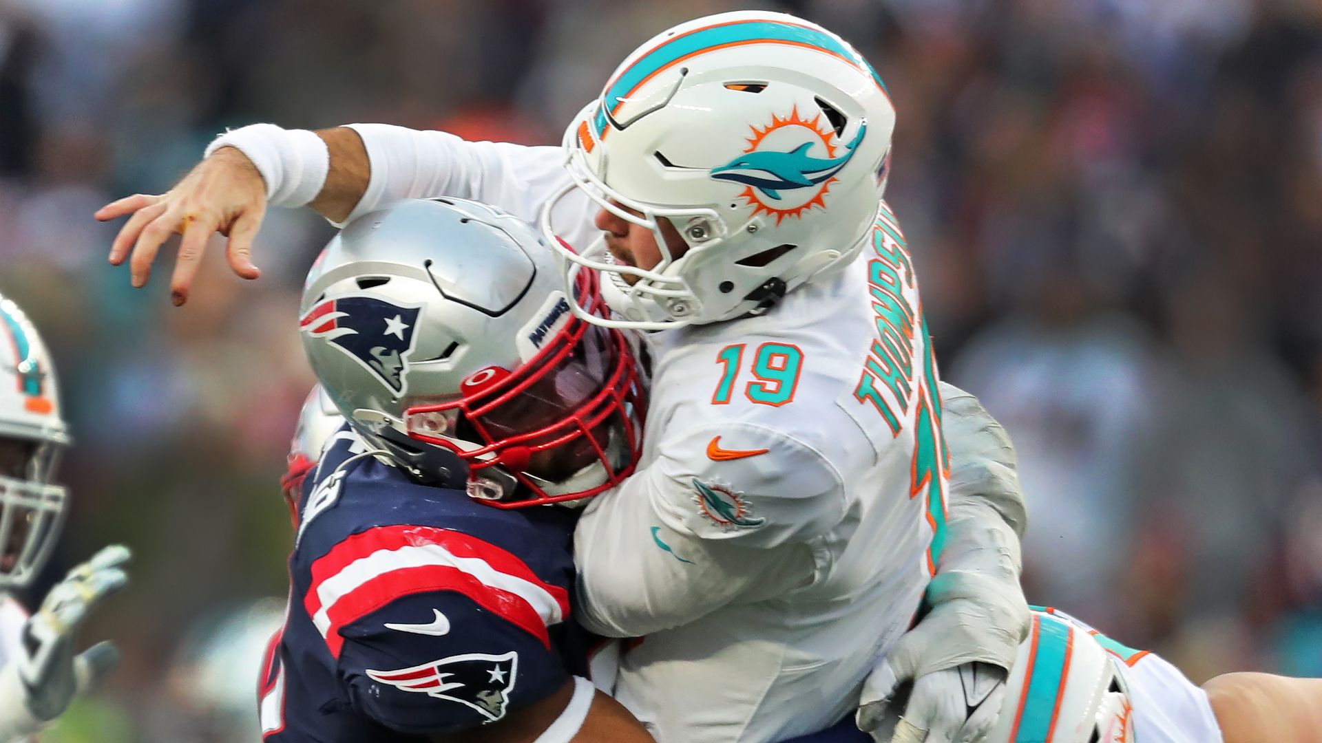 New England Patriots DL Deathrich Wise Jr. crashes into Miami Dolphins QB Skylar Thompson minutes after Thompson throws the ball. 