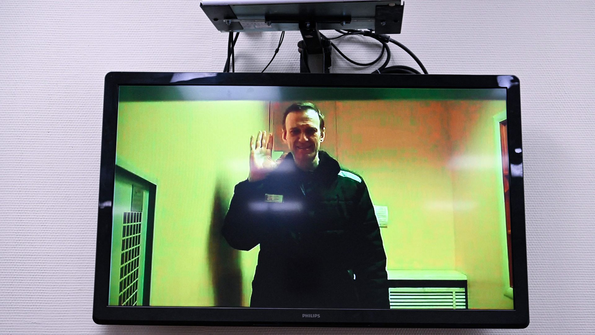 Alexei Navalny is seen on a screen via a video link from his penal colony before a hearing over the extremism criminal case against him