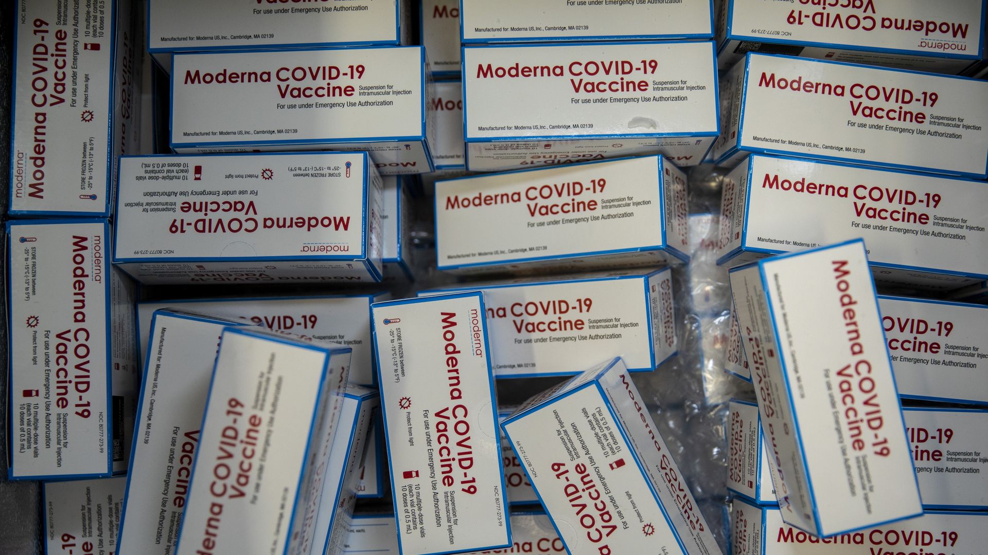 White boxes of Moderna's COVID-19 vaccine in a giant pile.