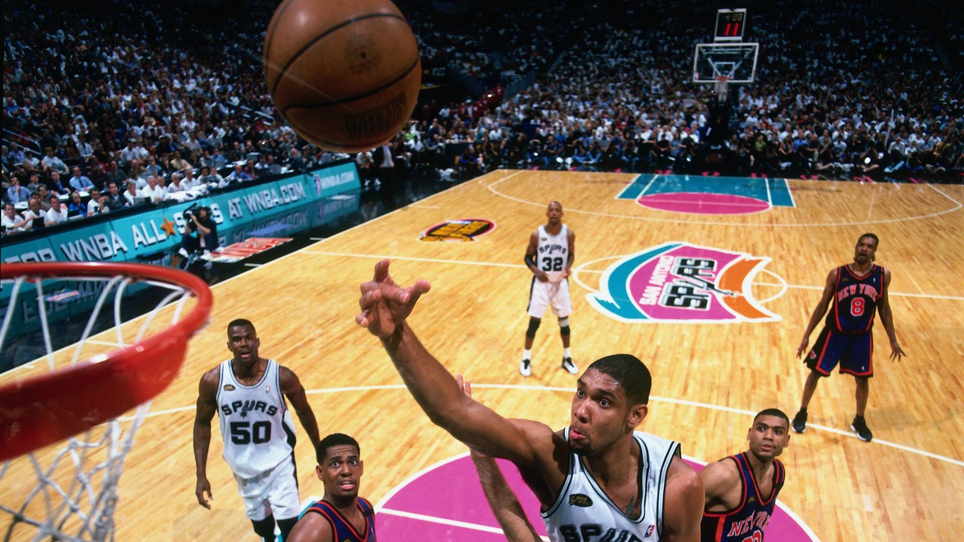 Spurs star Tim Duncan attempts a layup surrounded by New York Knicks players during the 1999 NBA Finals. 