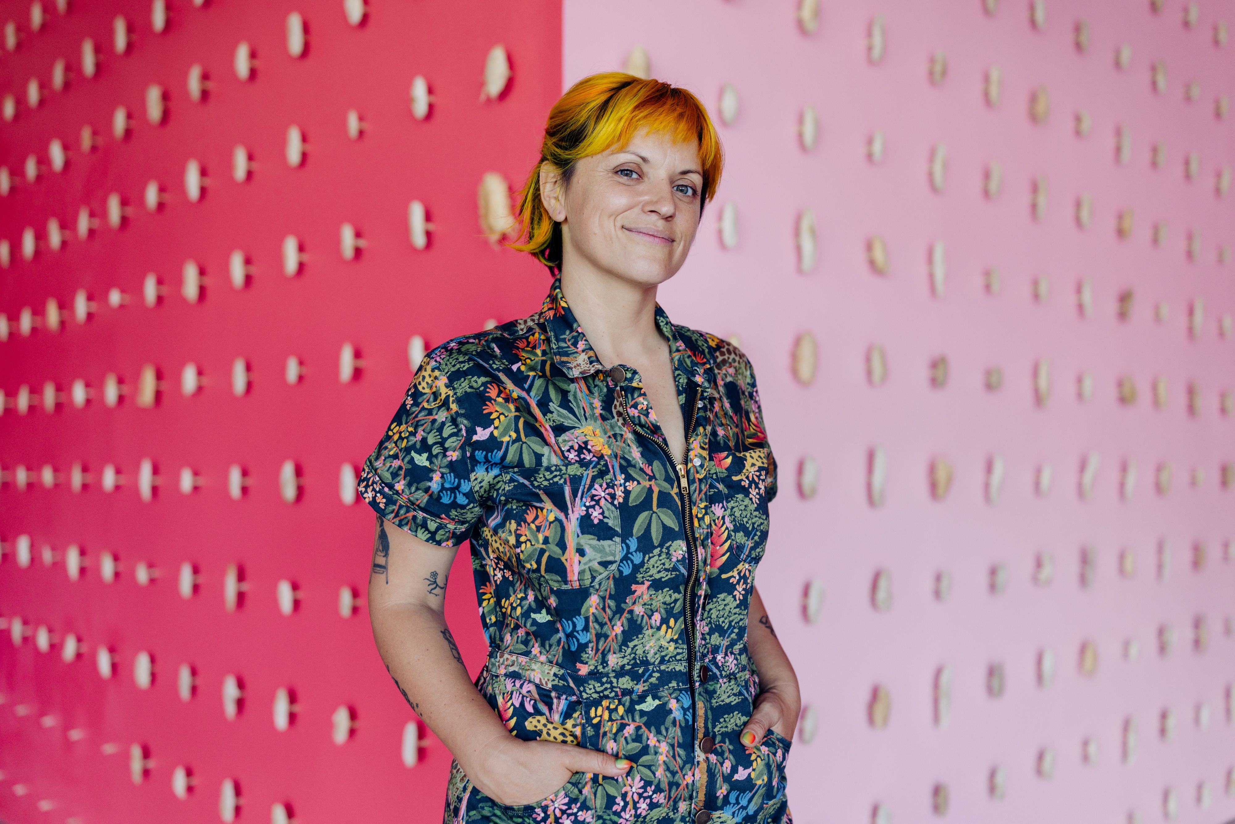 Jayme Kaye Gershen in front of a wall of mango husks
