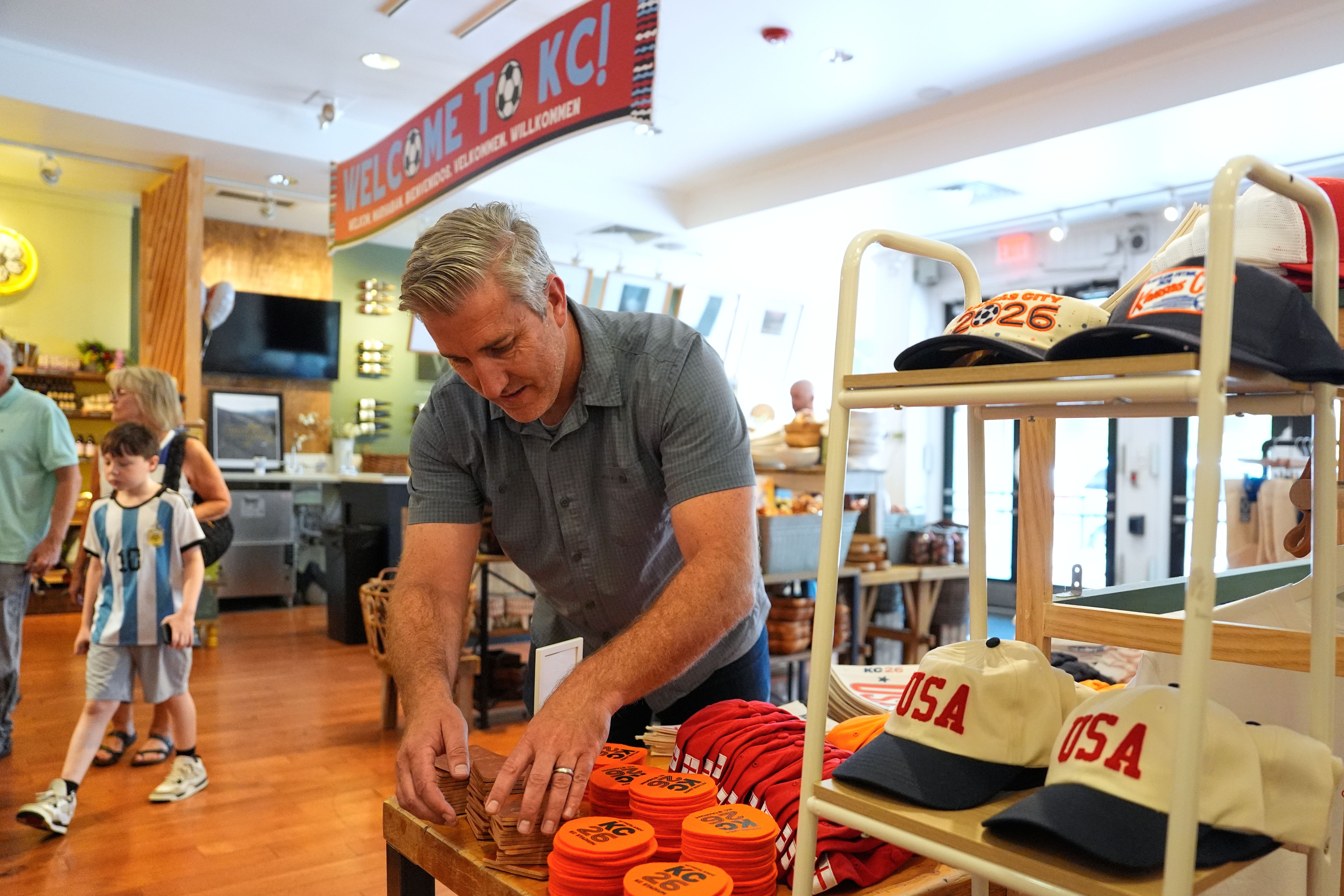 Shop owner adjusts items in a displau