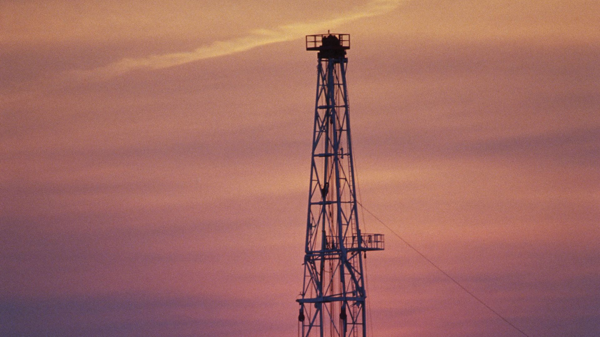 An oil well at sunset is silhouetted at sunset outside Jeddah, Saudi Arabia.