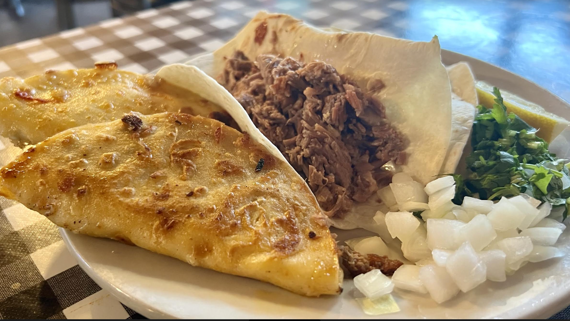 Two birria tacos and a barbacoa taco