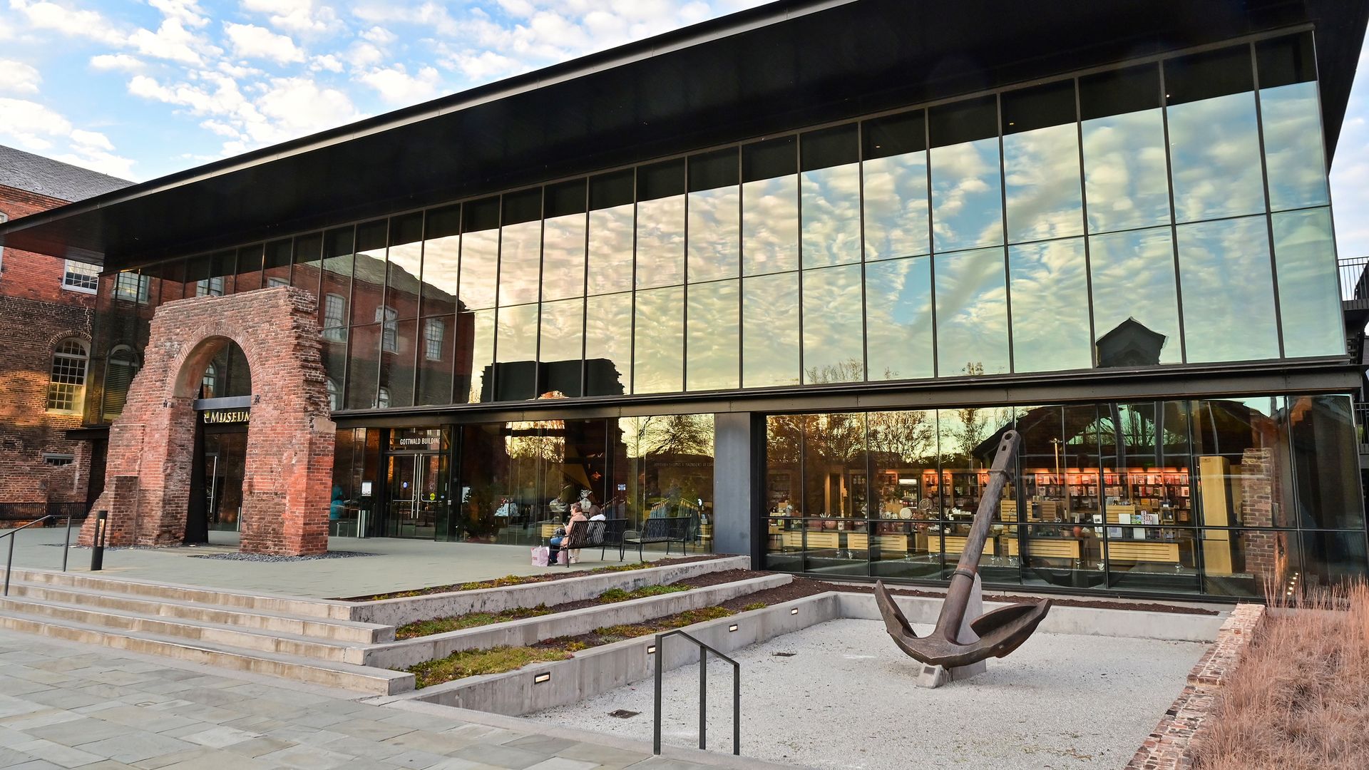 A cool glass building in front of old bricks