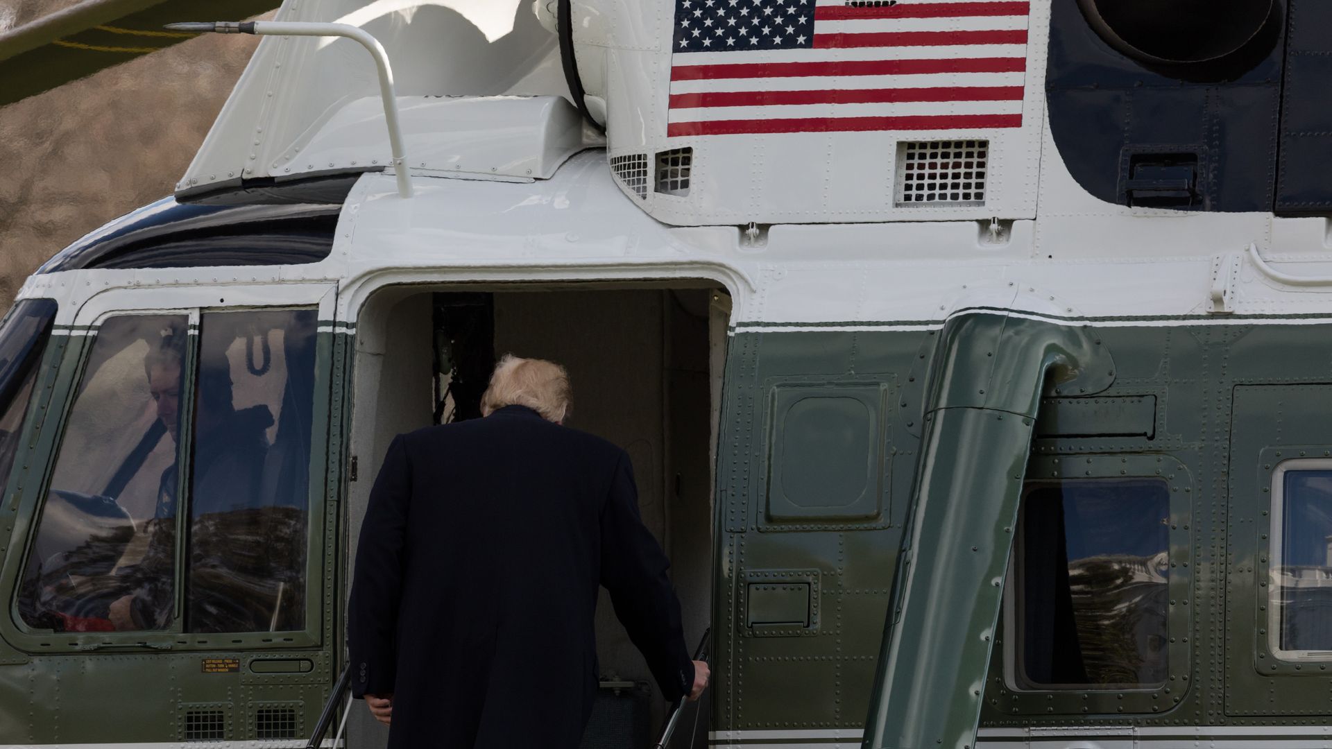 Trump entering a helicopter