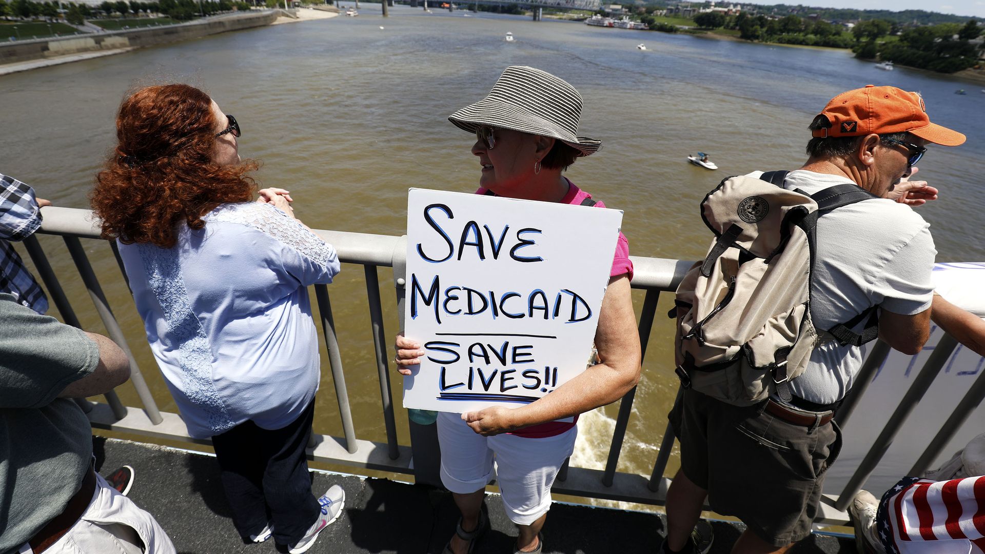 Kentucky woman with sign that says save medicare saves lives