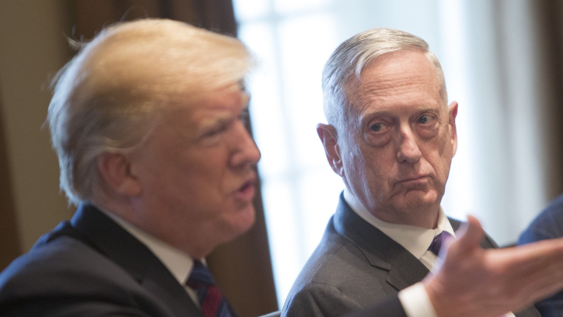 James Mattis looks at President Trump, who is speaking