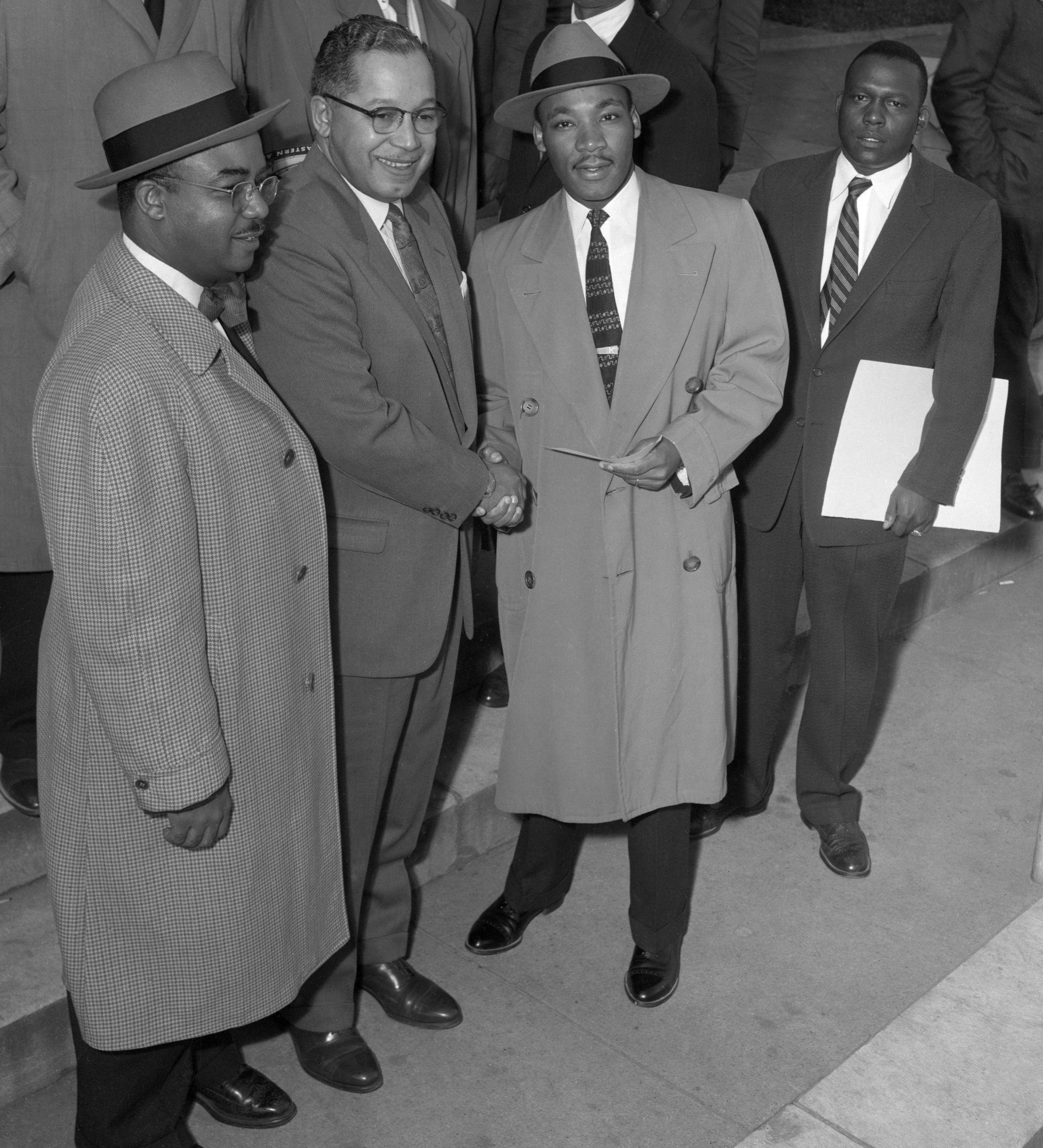 James E. Huger (center), Gen. Secretary of Alphi Phi Alpha fraternity, presents a check for $1,000 to Rev. Martin Luther King as they arrived for the second day in court. King is charged with leading a 15-week racial boycott against the Montgomery's segregated buses.