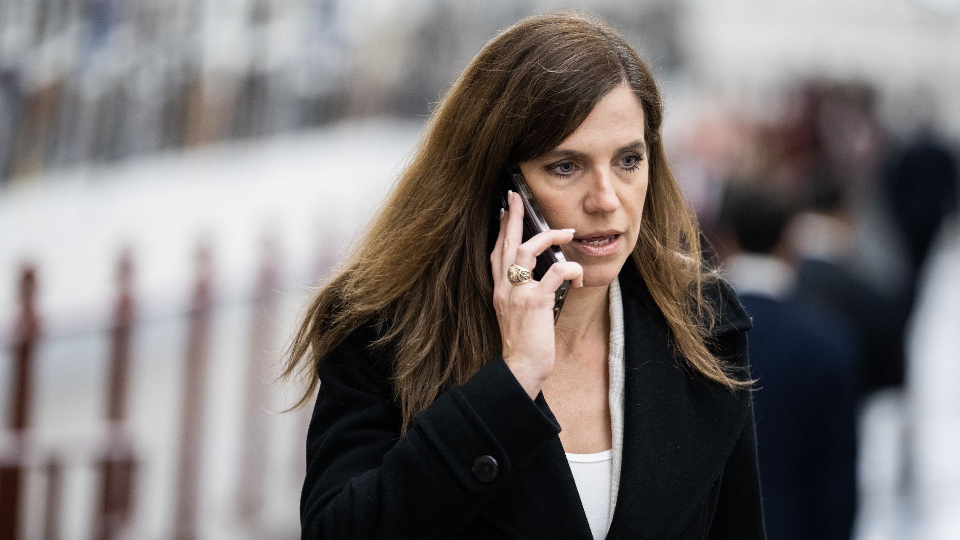 Rep. Nancy Mace, wearing a dark blue blazer, white shirt and talking on a cellphone.