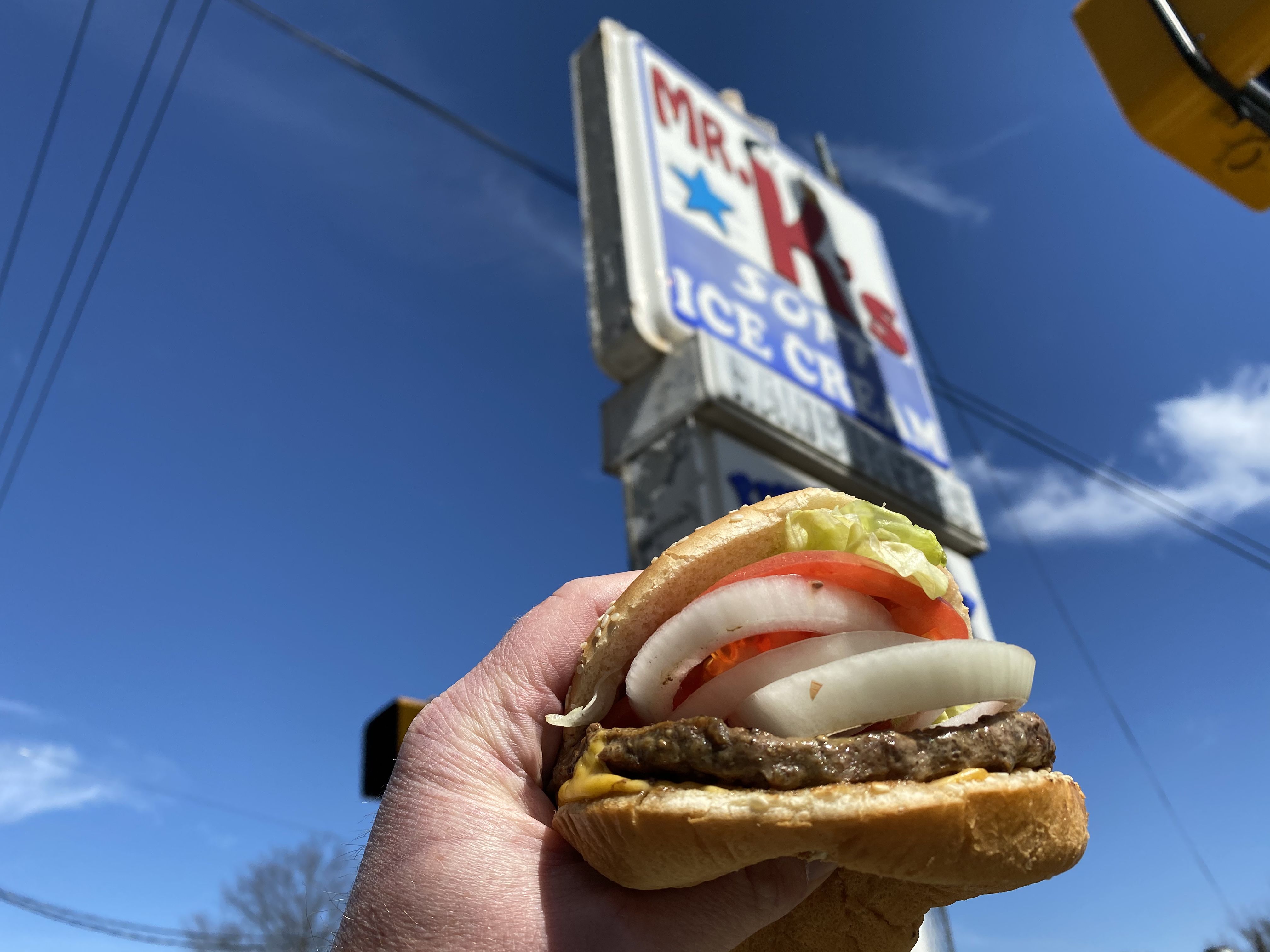 image of burger with onions, tomatoes and lettuce