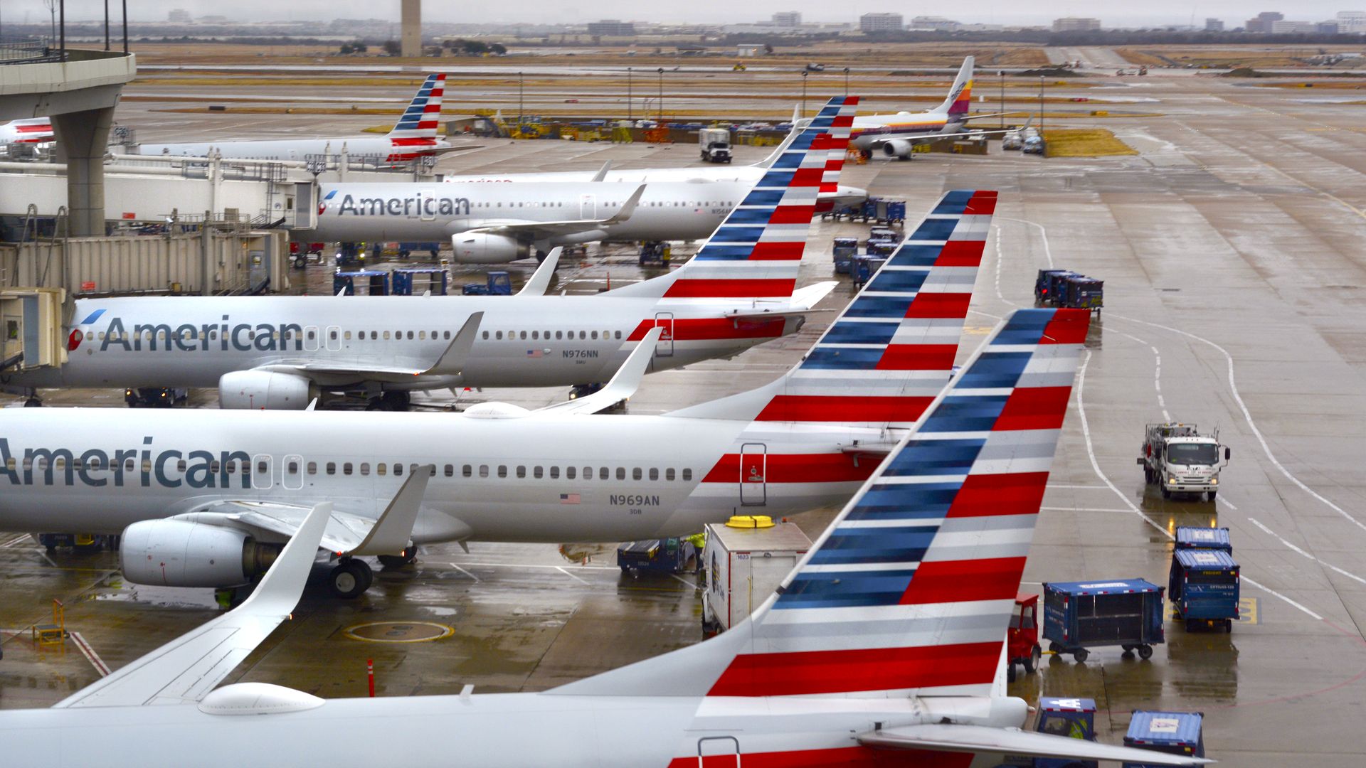 American Airlines planes parked at the gate of an airport.