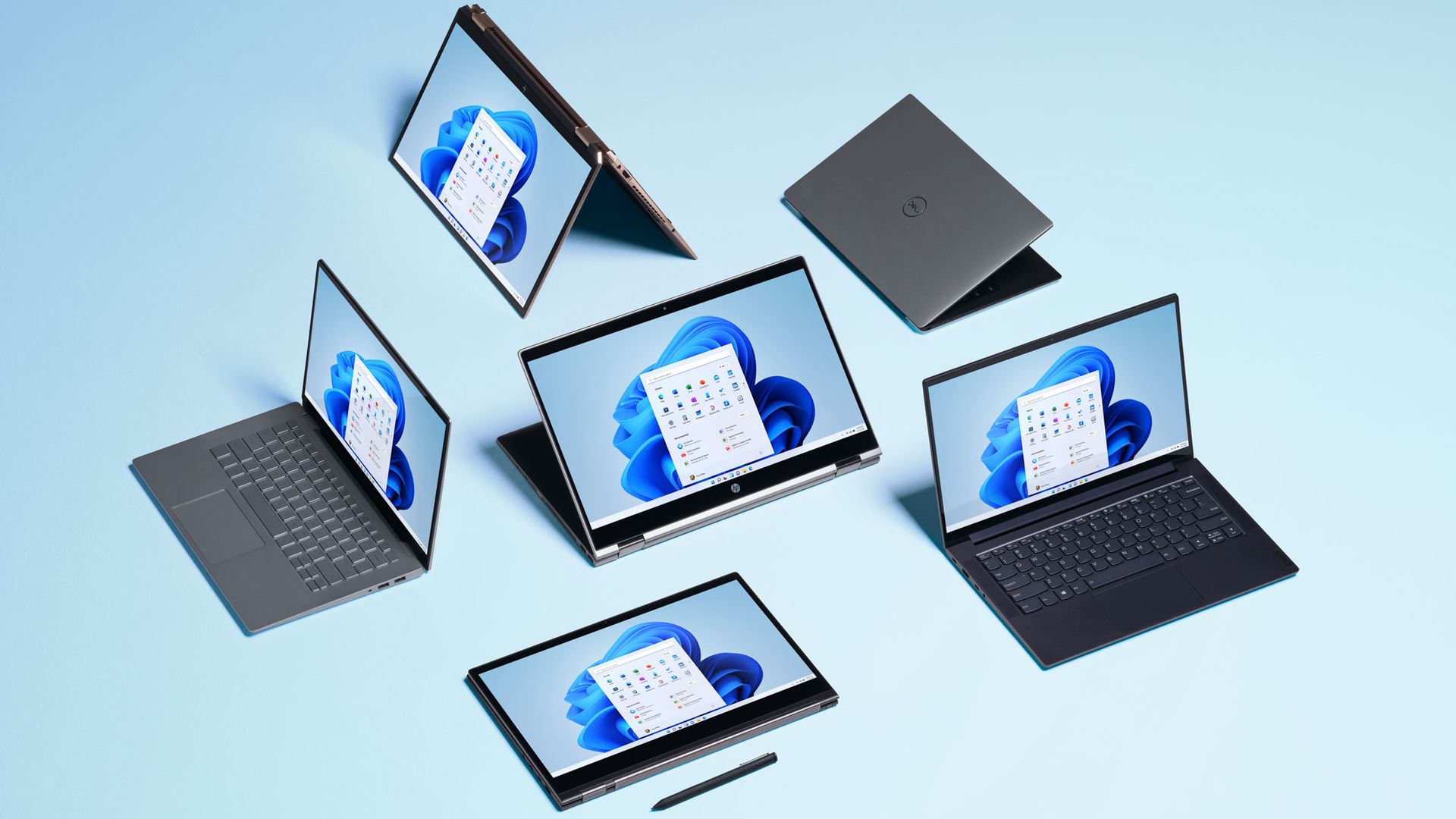 An image with tablets and laptops running Windows 11